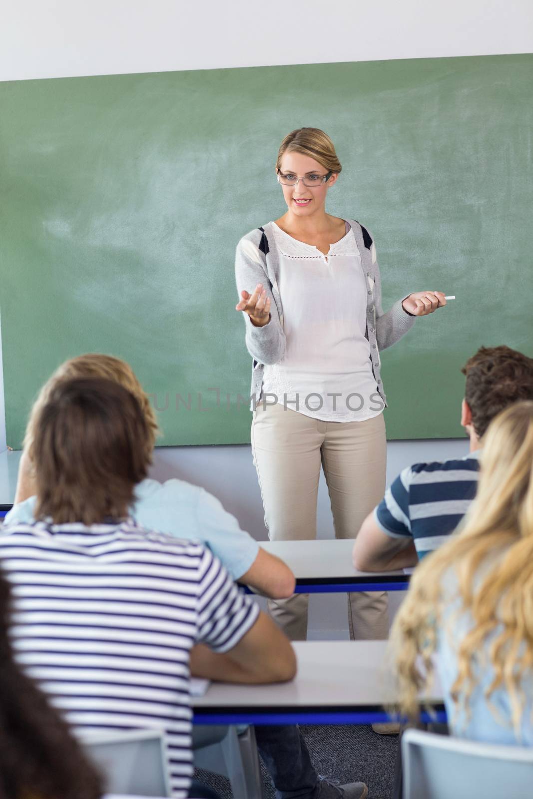 Female teacher teaching students in the class