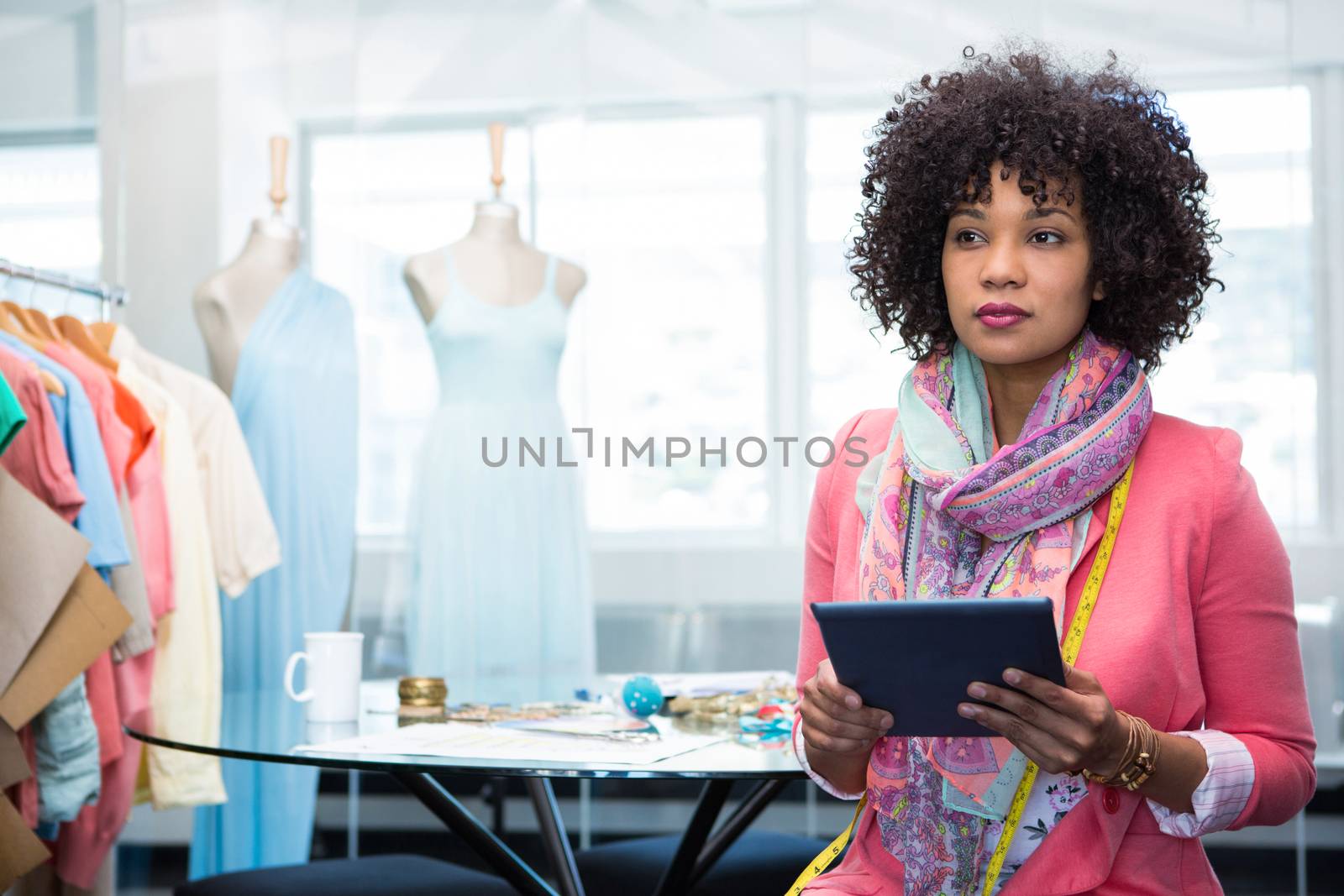 Attractive female fashion designer using digital tablet