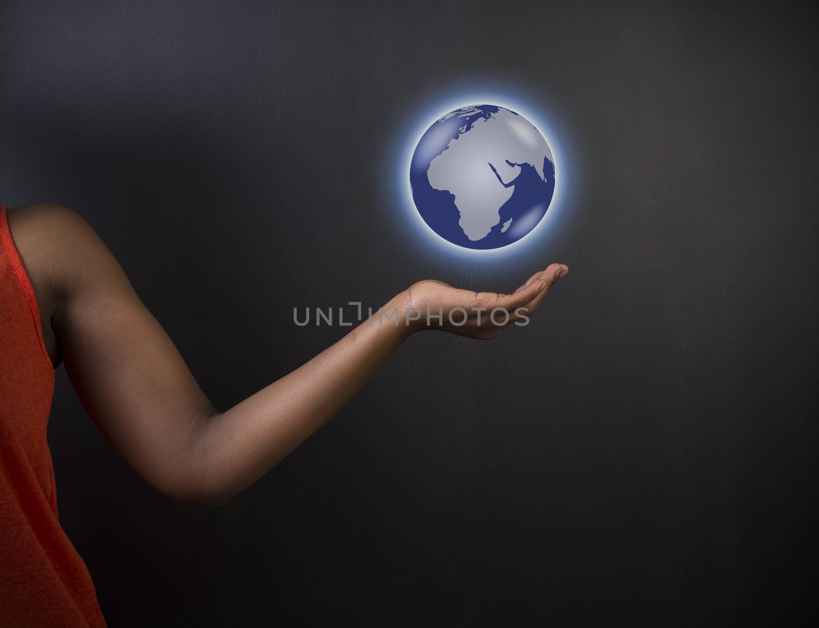 South African or African American woman teacher or student holding world earth globe in the palm of her had on black background
