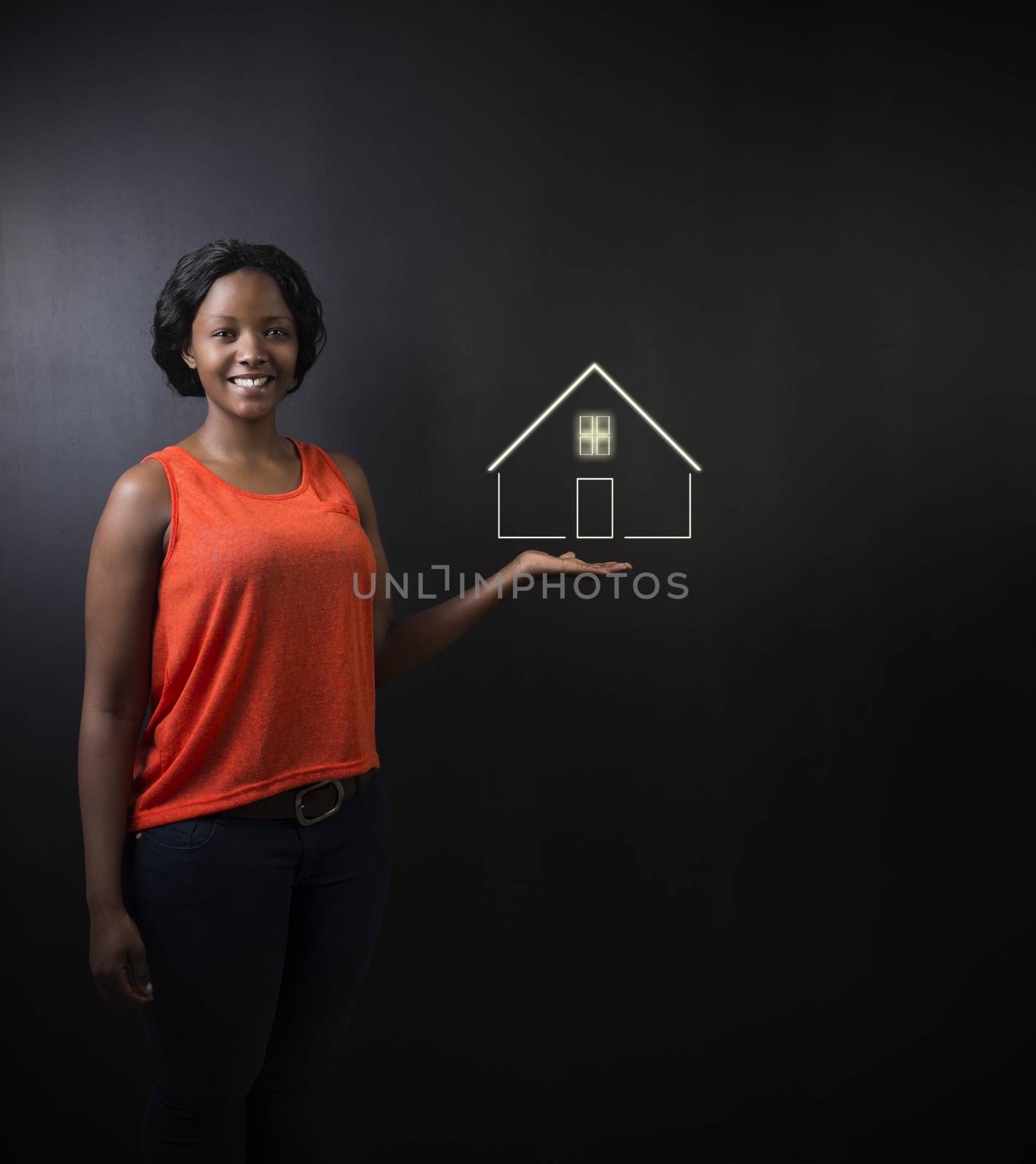 South African or African American woman teacher, student, saleswoman or businesswoman against black background holding house, home or real estate