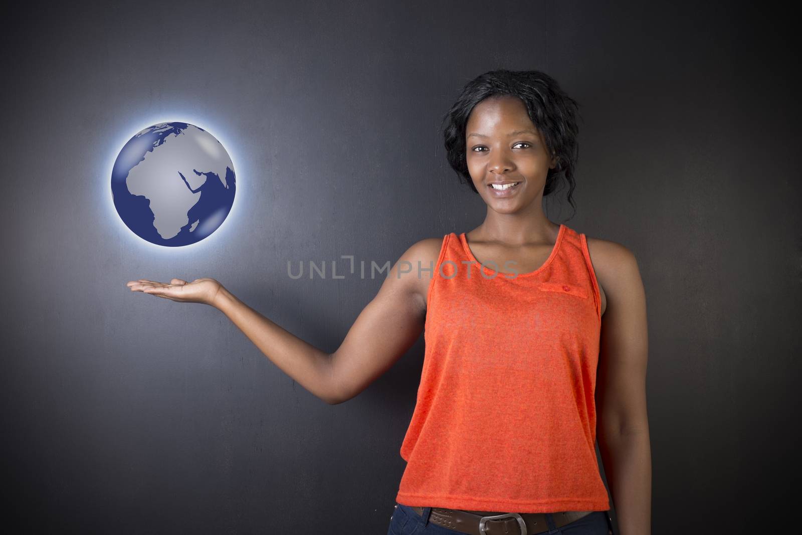 South African or African American woman teacher or student holding world earth globe in the palm of her had on black background