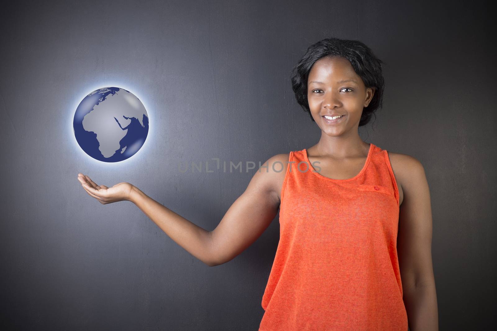 South African or African American woman teacher or student holding world earth globe in the palm of her had on black background