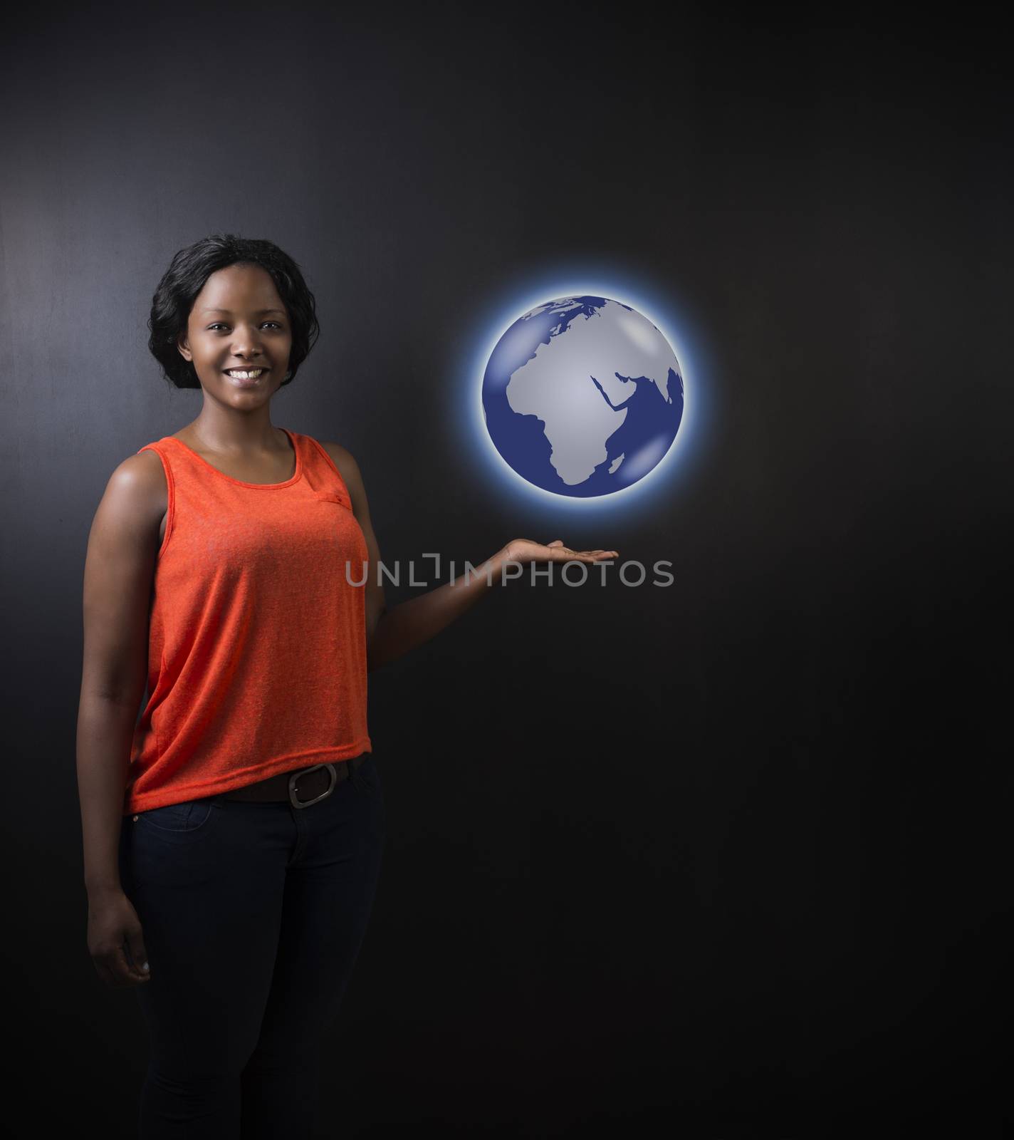 South African or African American woman teacher or student holding world earth globe in the palm of her had on black background