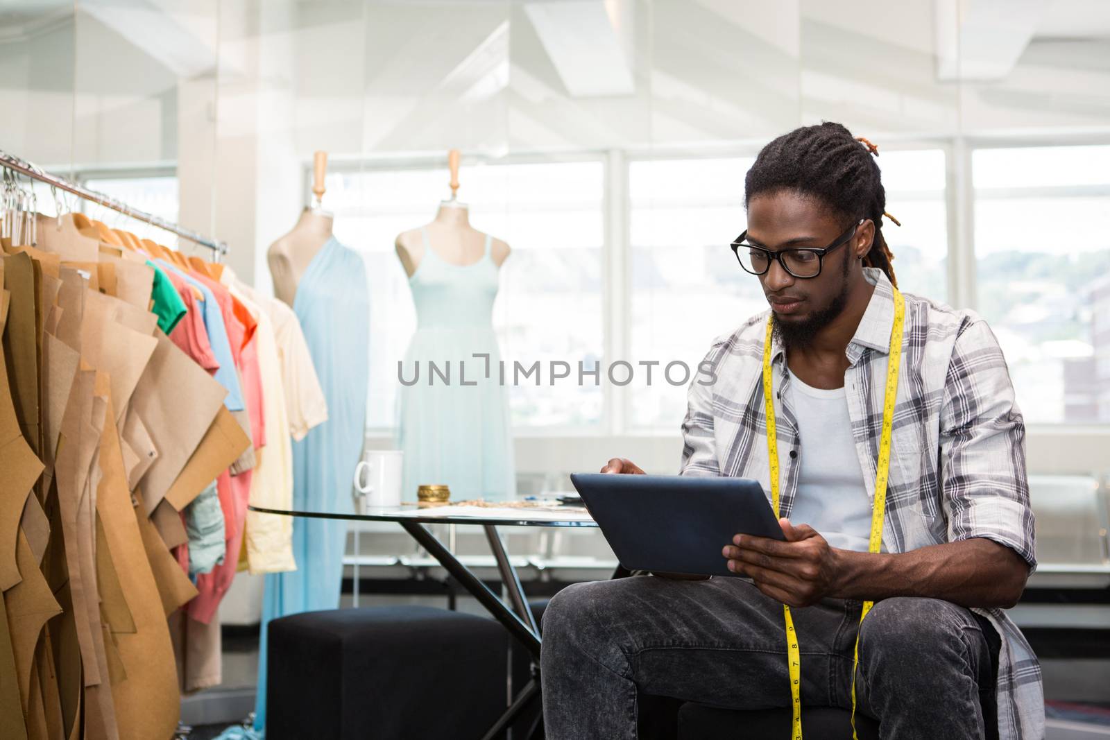 Male fashion designer using digital tablet