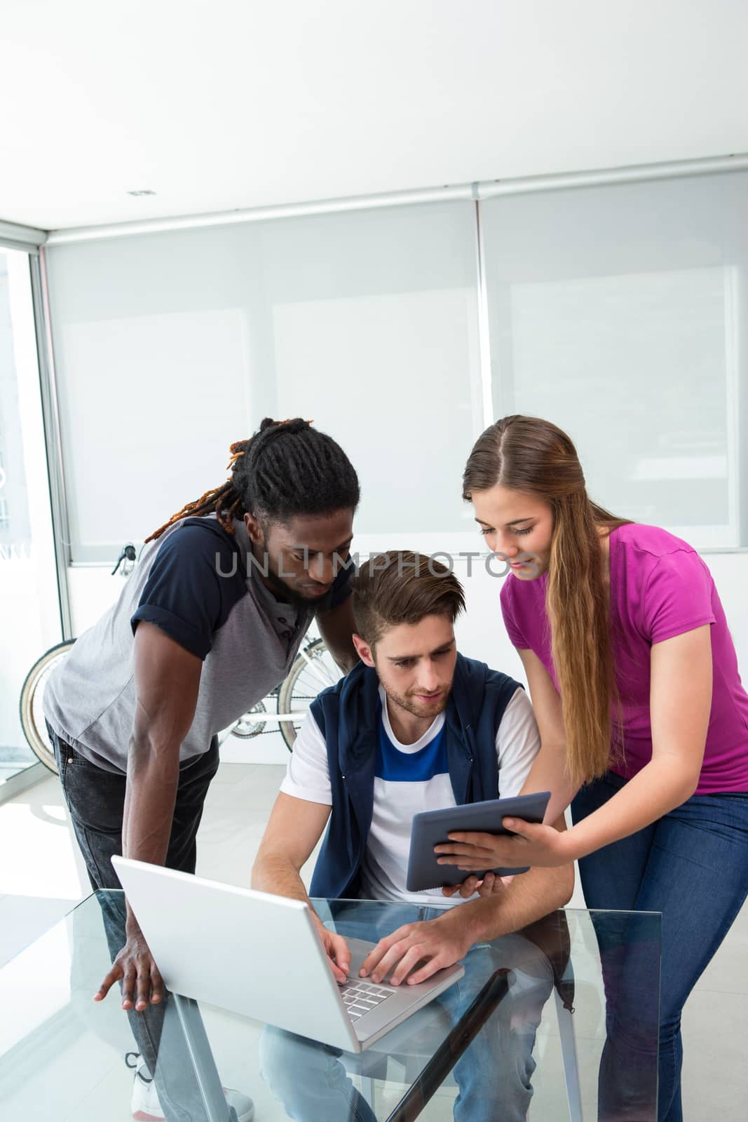 Creative team looking at digital tablet in the office