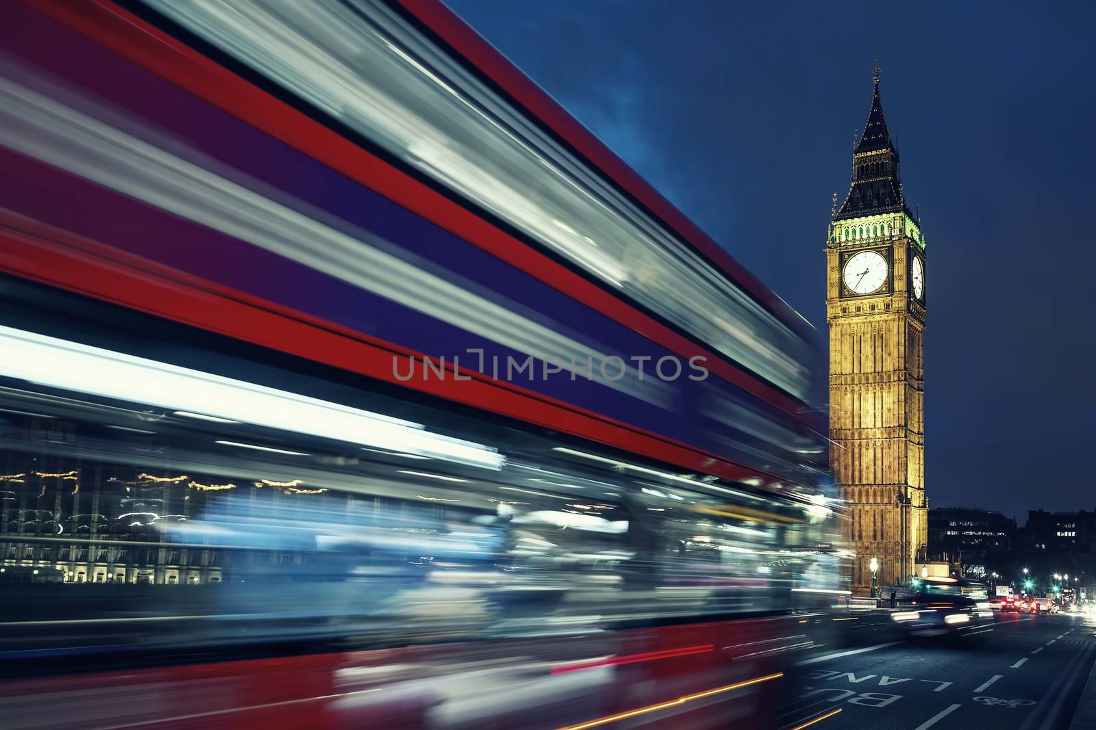 Big Ben, one of the most prominent symbols of both London and England, as shown at night along with the lights of the cars passing by