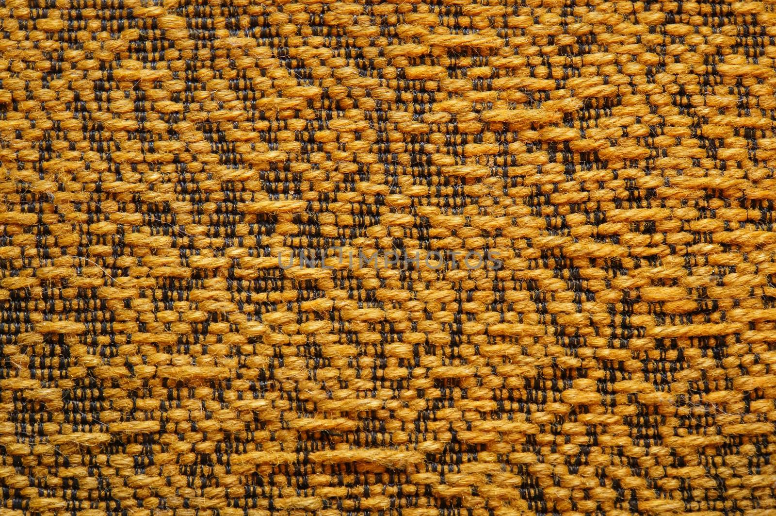 Woolen upholstery with orange color with a pattern of black thread as abstract background