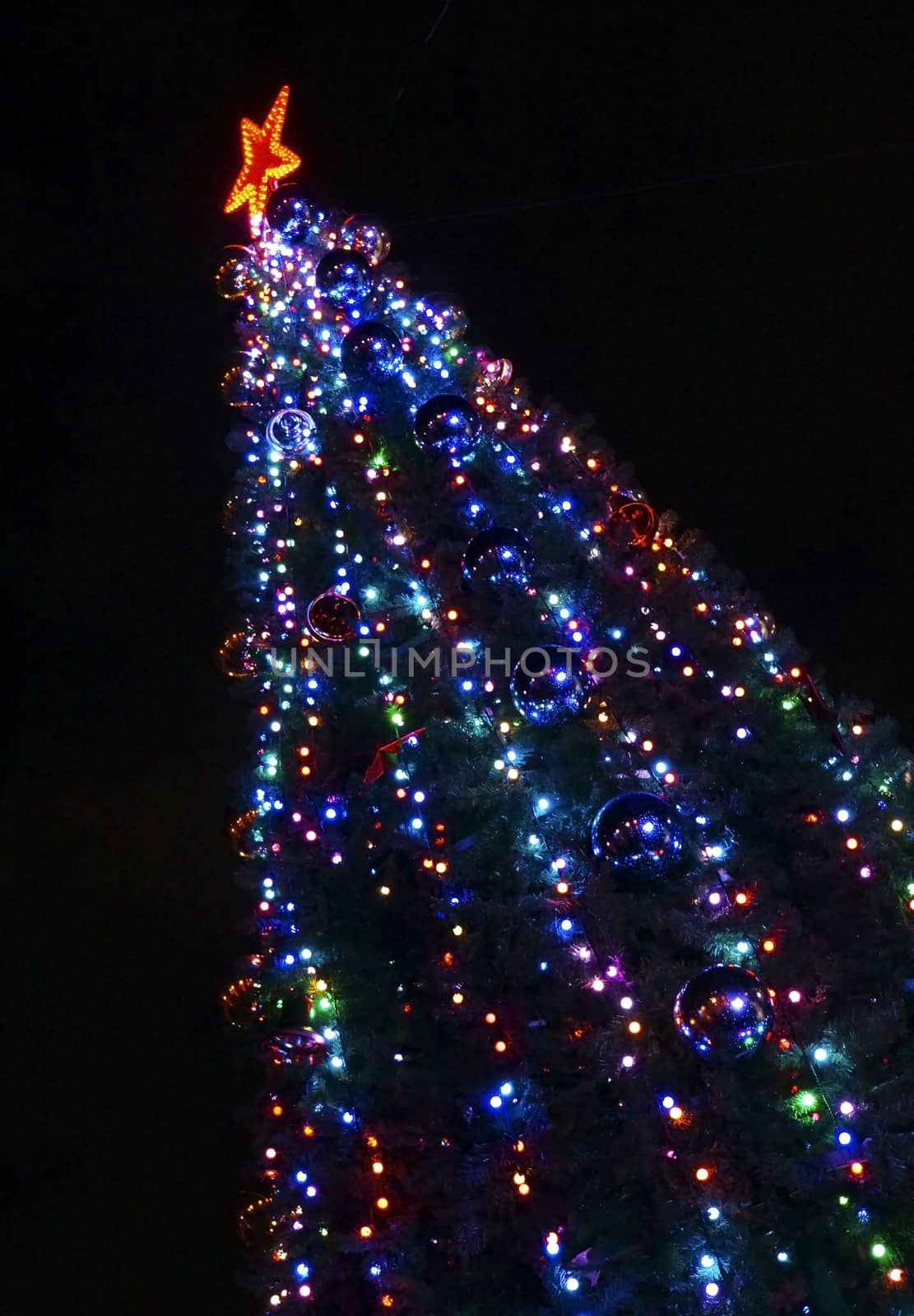 Christmas tree decorated with colorful bright lights cropped dia by Chiffanna