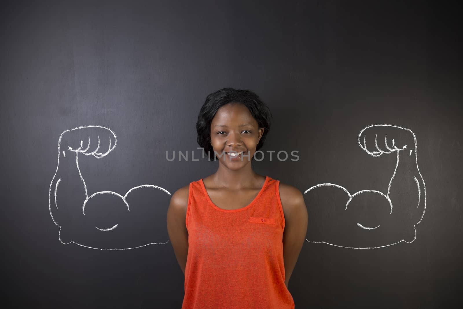 South African or African American woman teacher with healthy strong arm muscles for success on blackboard background