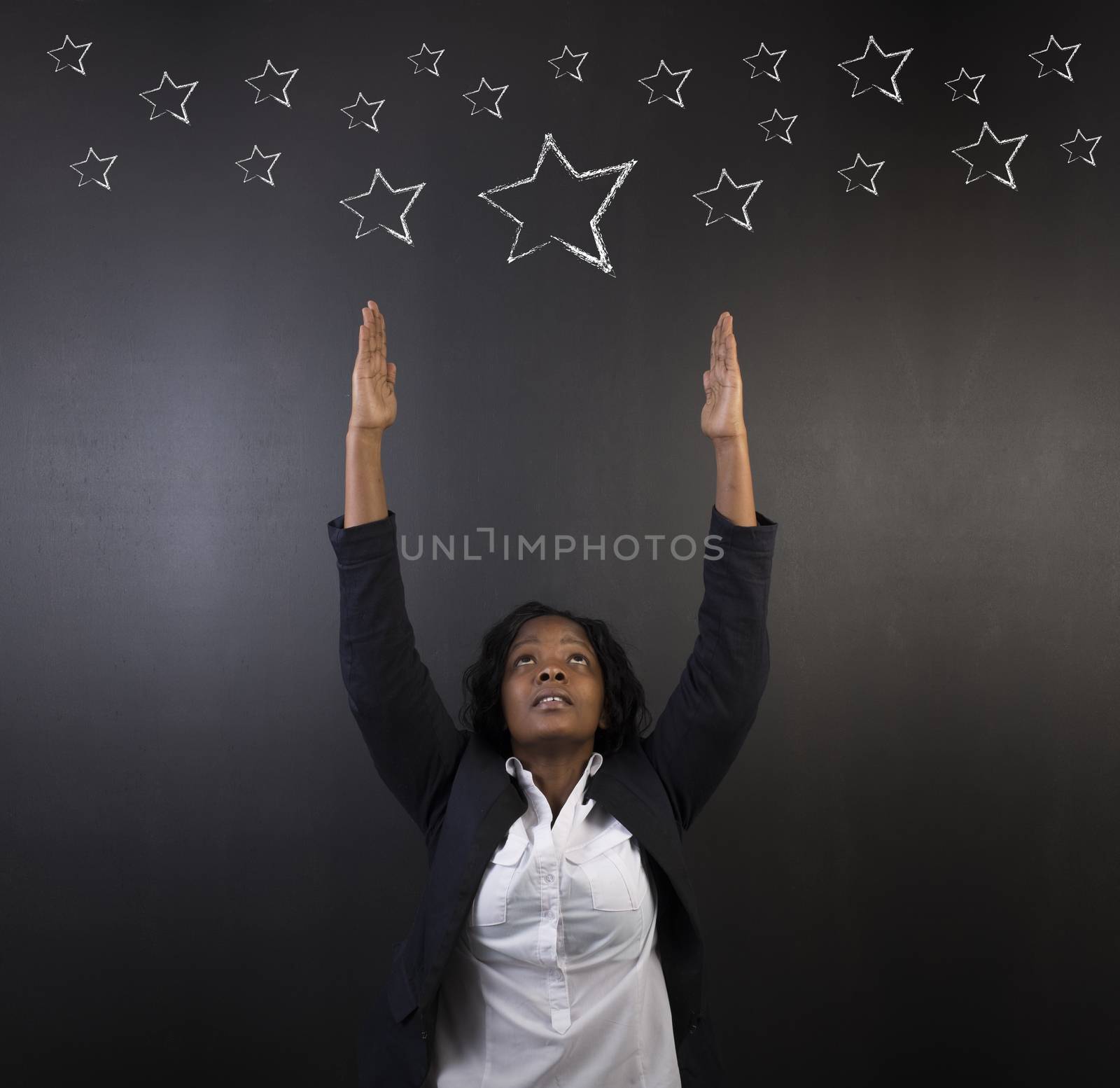 South African or African American woman teacher or student reaching for the stars success by alistaircotton