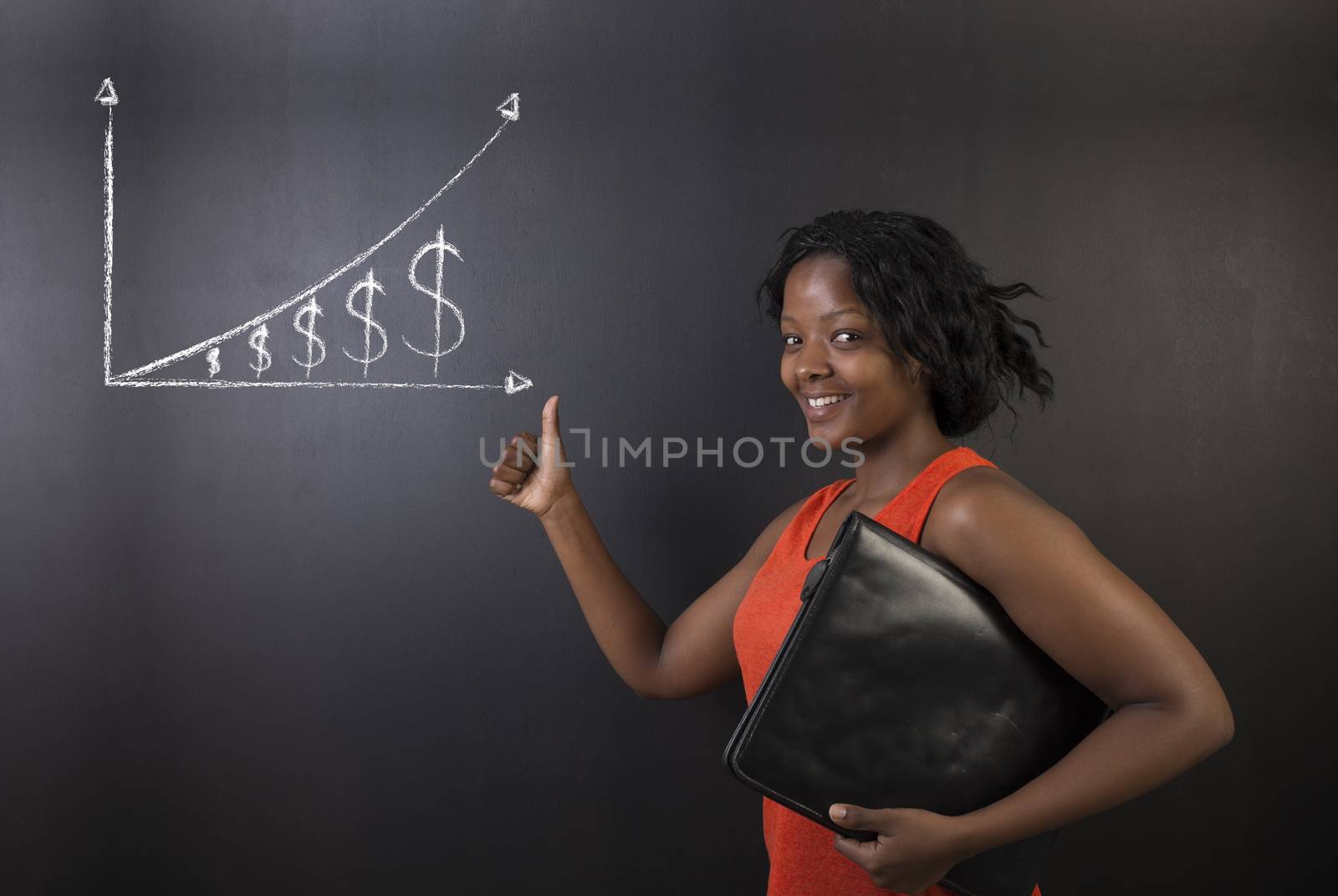 South African or African American woman teacher or student thumbs up holding a diary or book against a blackboard background with a chalk money graph