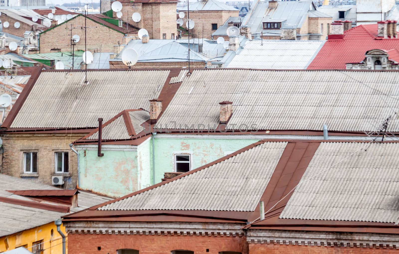 city landscape with old roofs and dish antennas