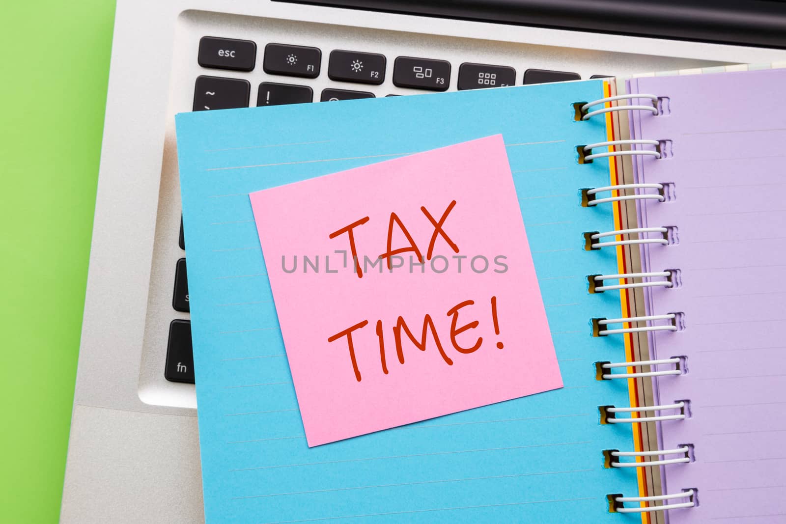 Notepad with word " TAX TIME " on paper book  by vinnstock