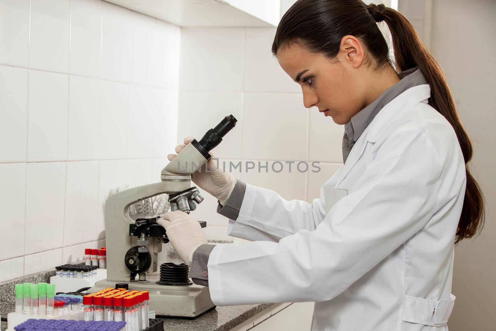 woman looking at the microscope