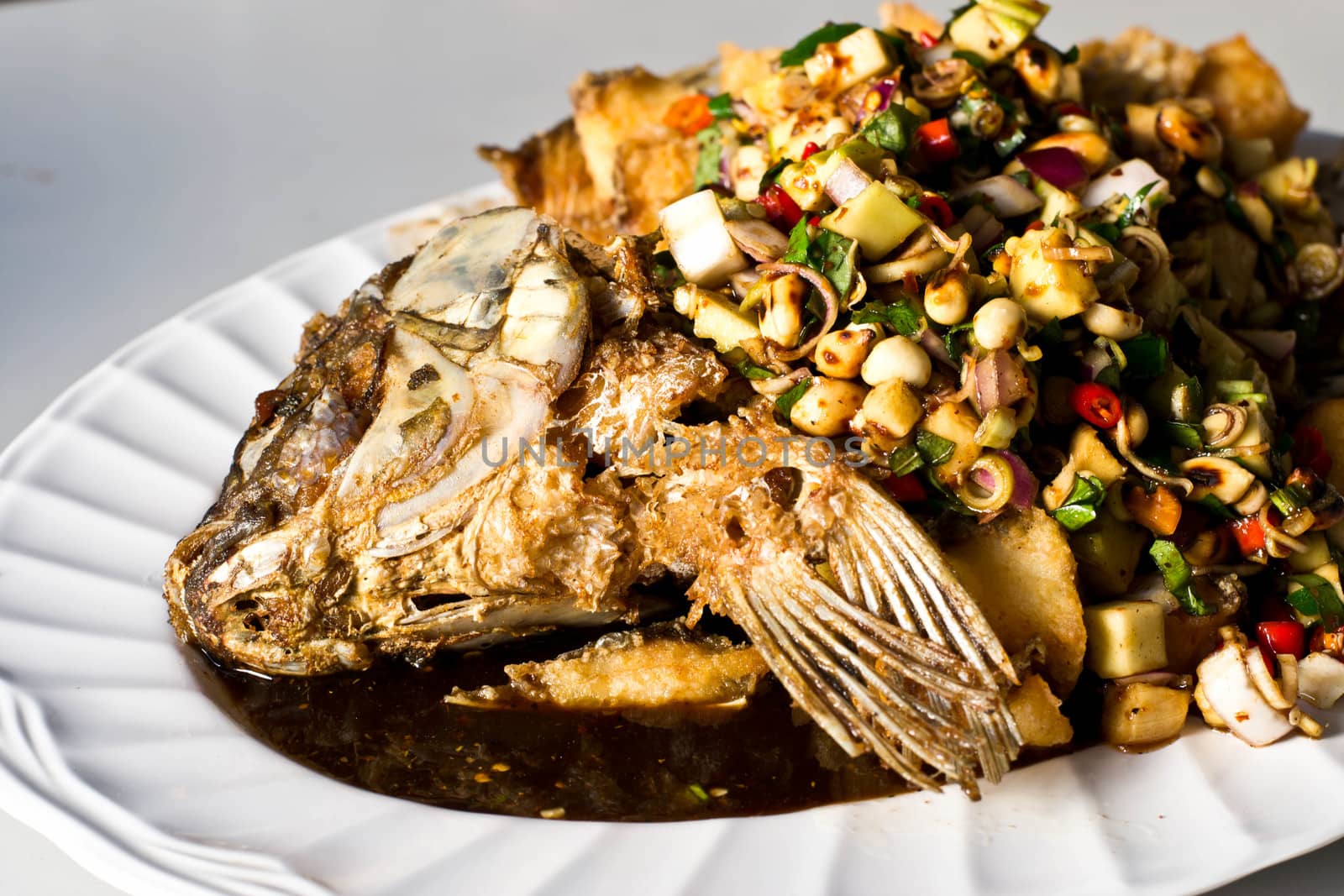 Fried tilapia and spices on dish