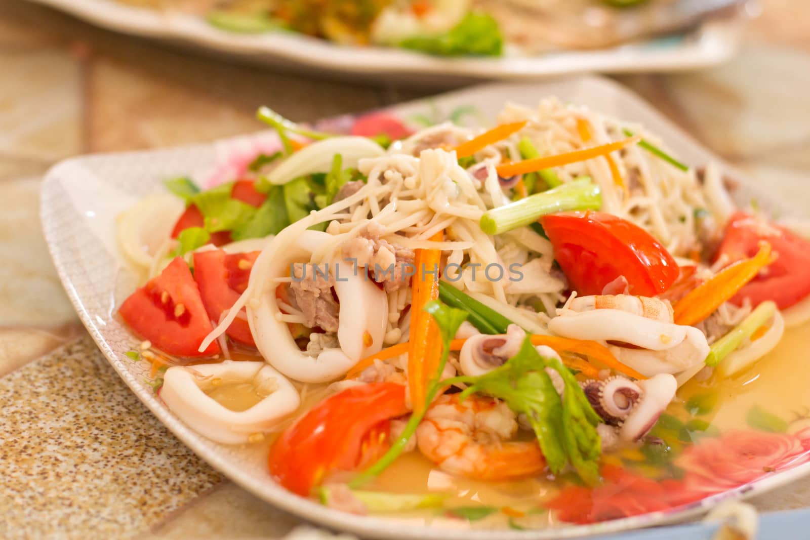 Seafood salad on a plate by Thanamat