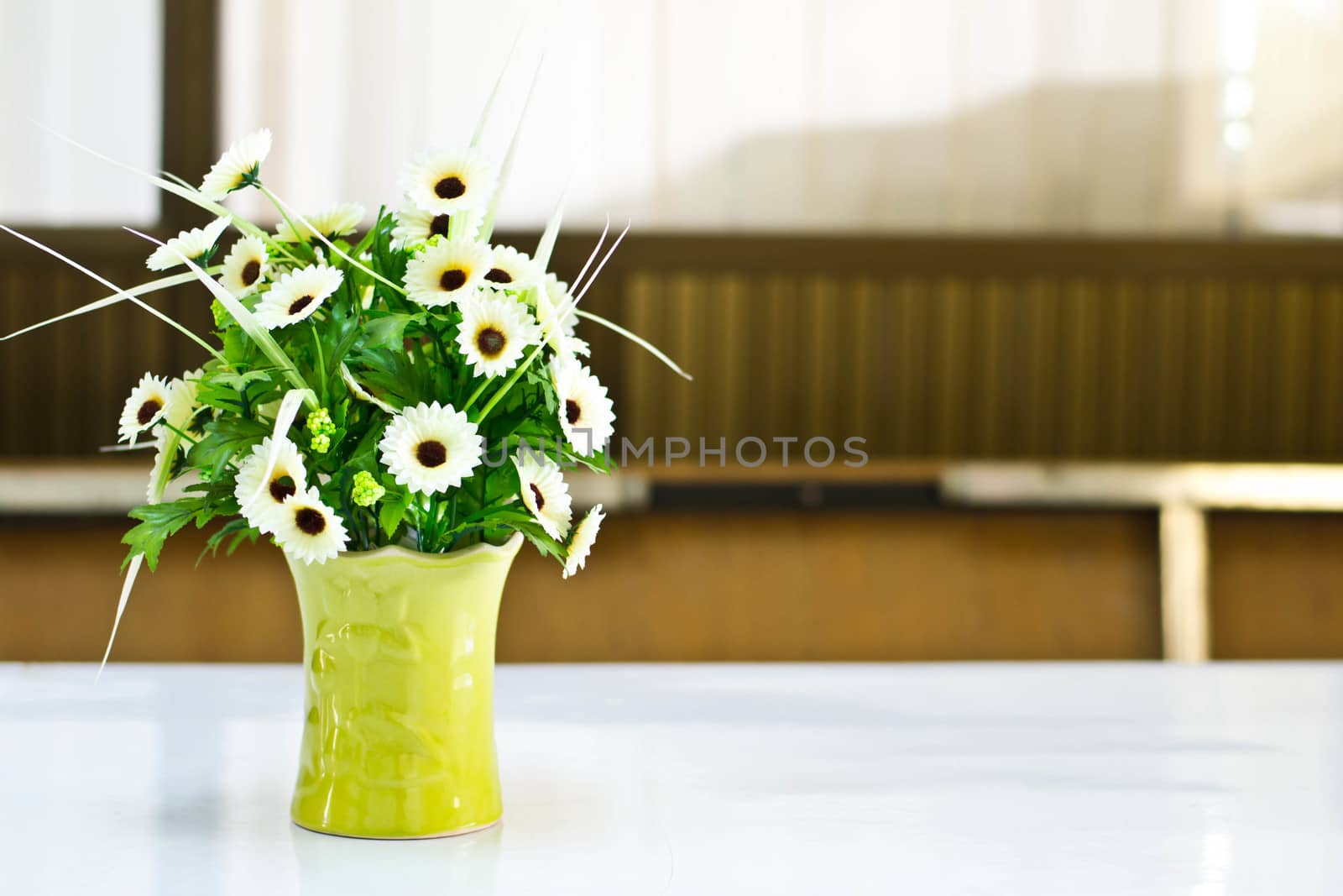  Beautiful flower in a vase on wooden table by Thanamat