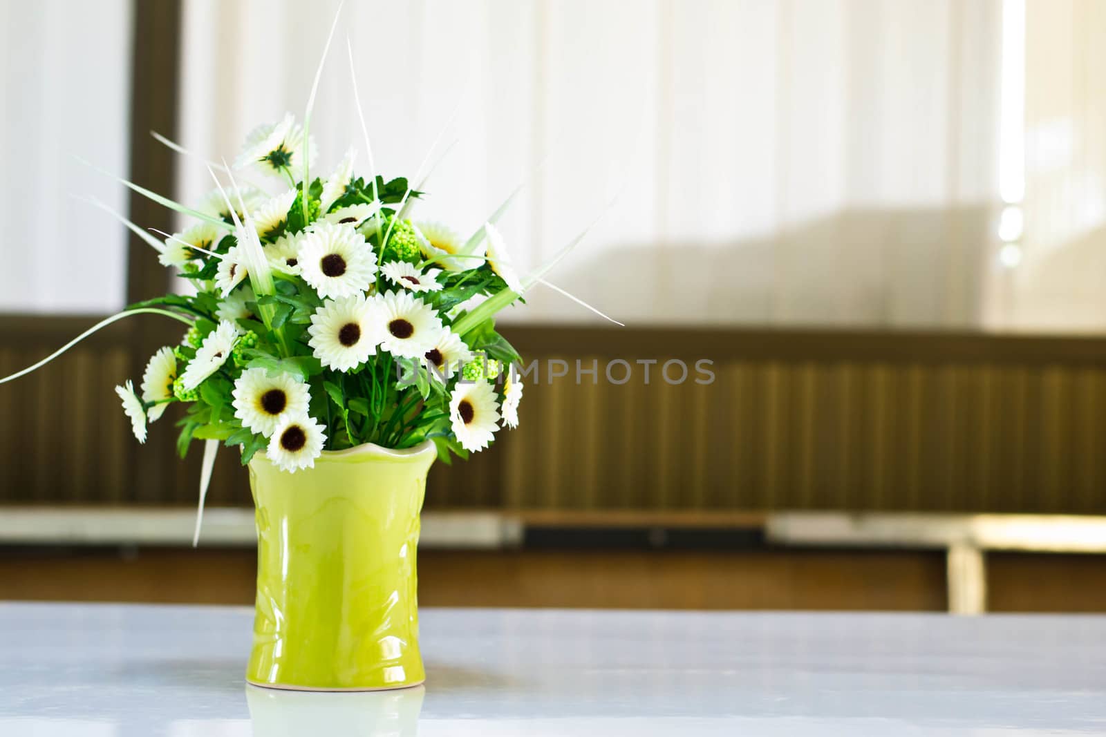  Beautiful flower in a vase on wooden table by Thanamat