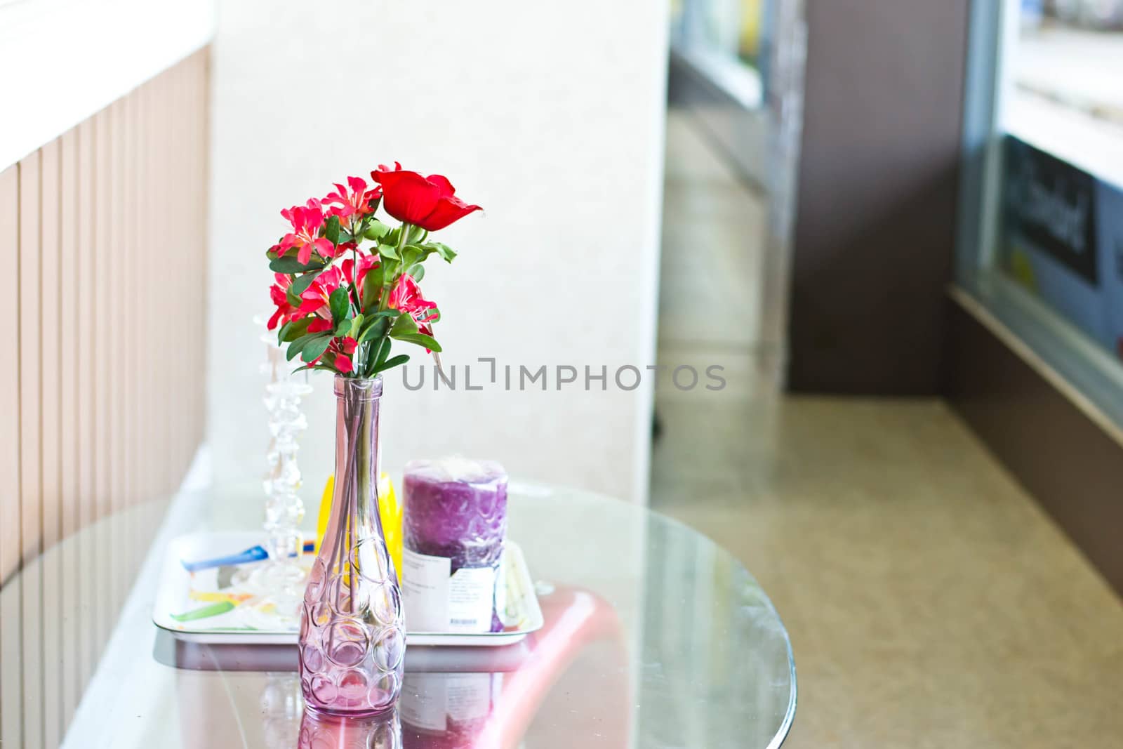 Flowers in a vase on the table by Thanamat