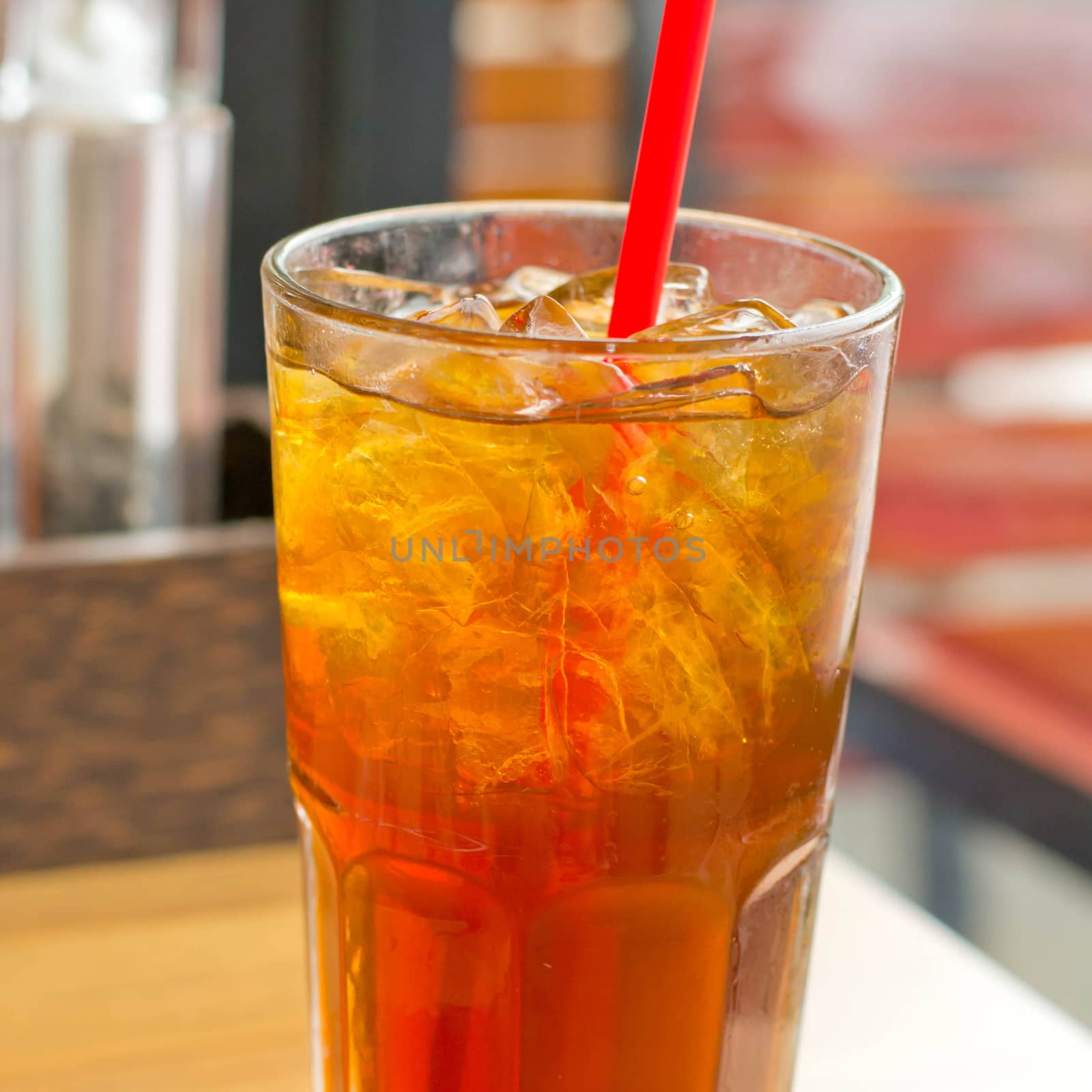 Lemon tea with ice in a glass by Thanamat