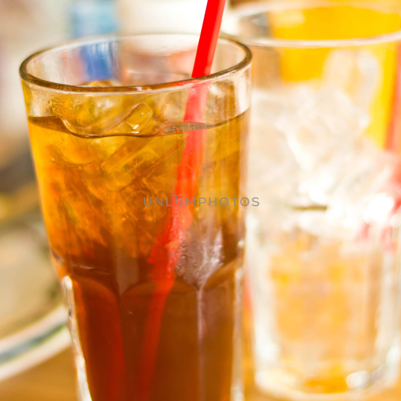 Lemon tea with ice in a glass by Thanamat