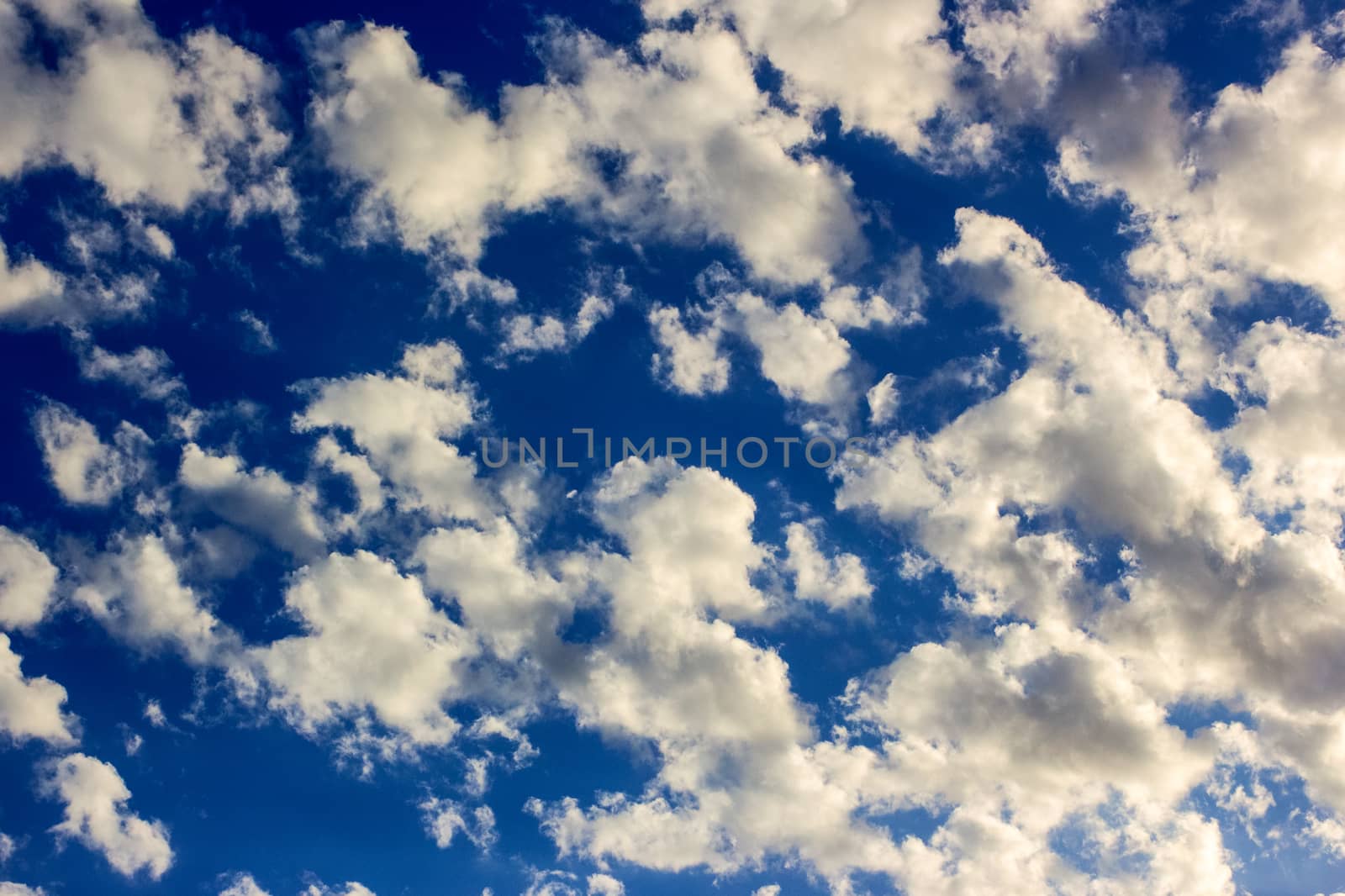 many white clouds in a beautiful blue sky