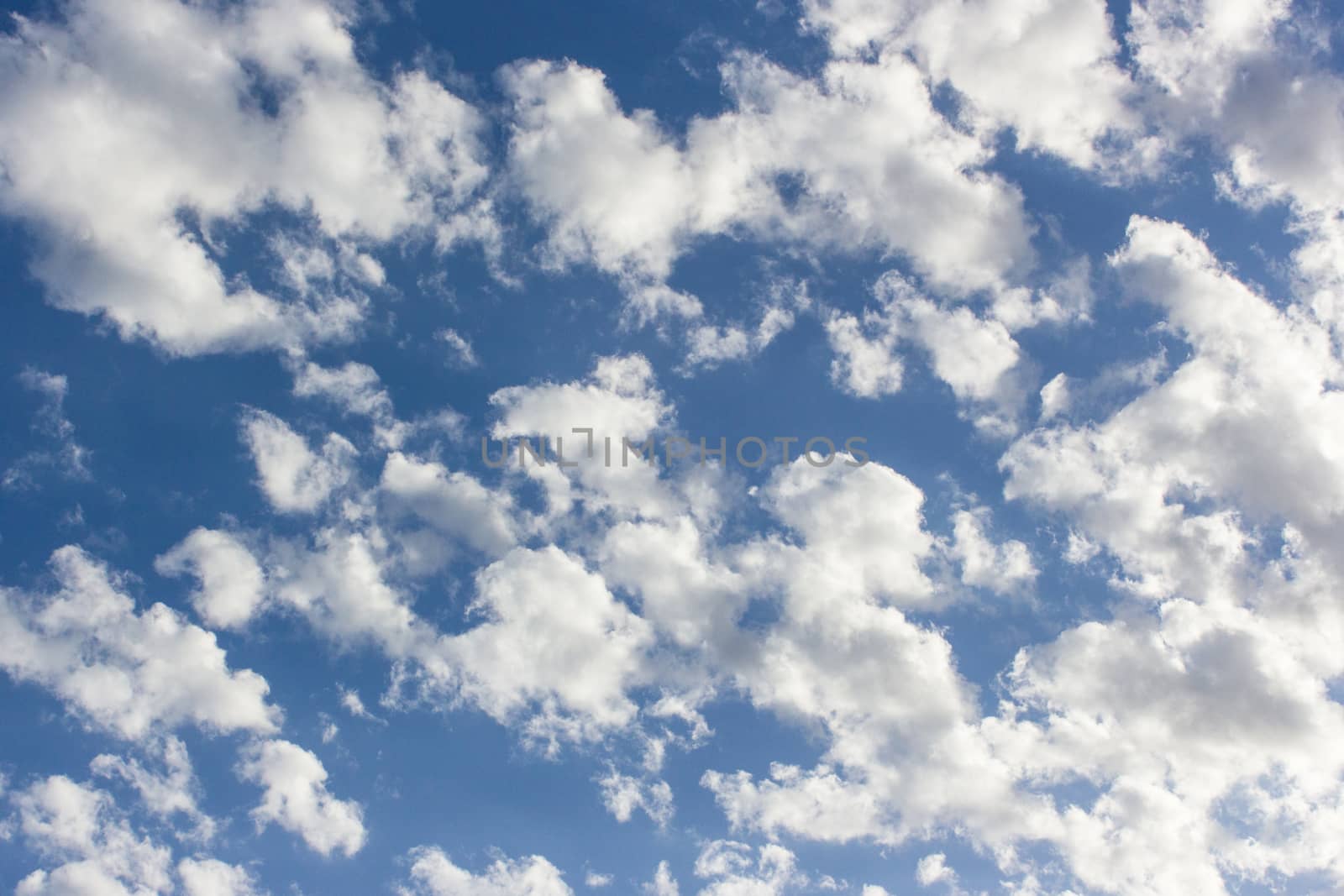 many white clouds in a beautiful blue sky