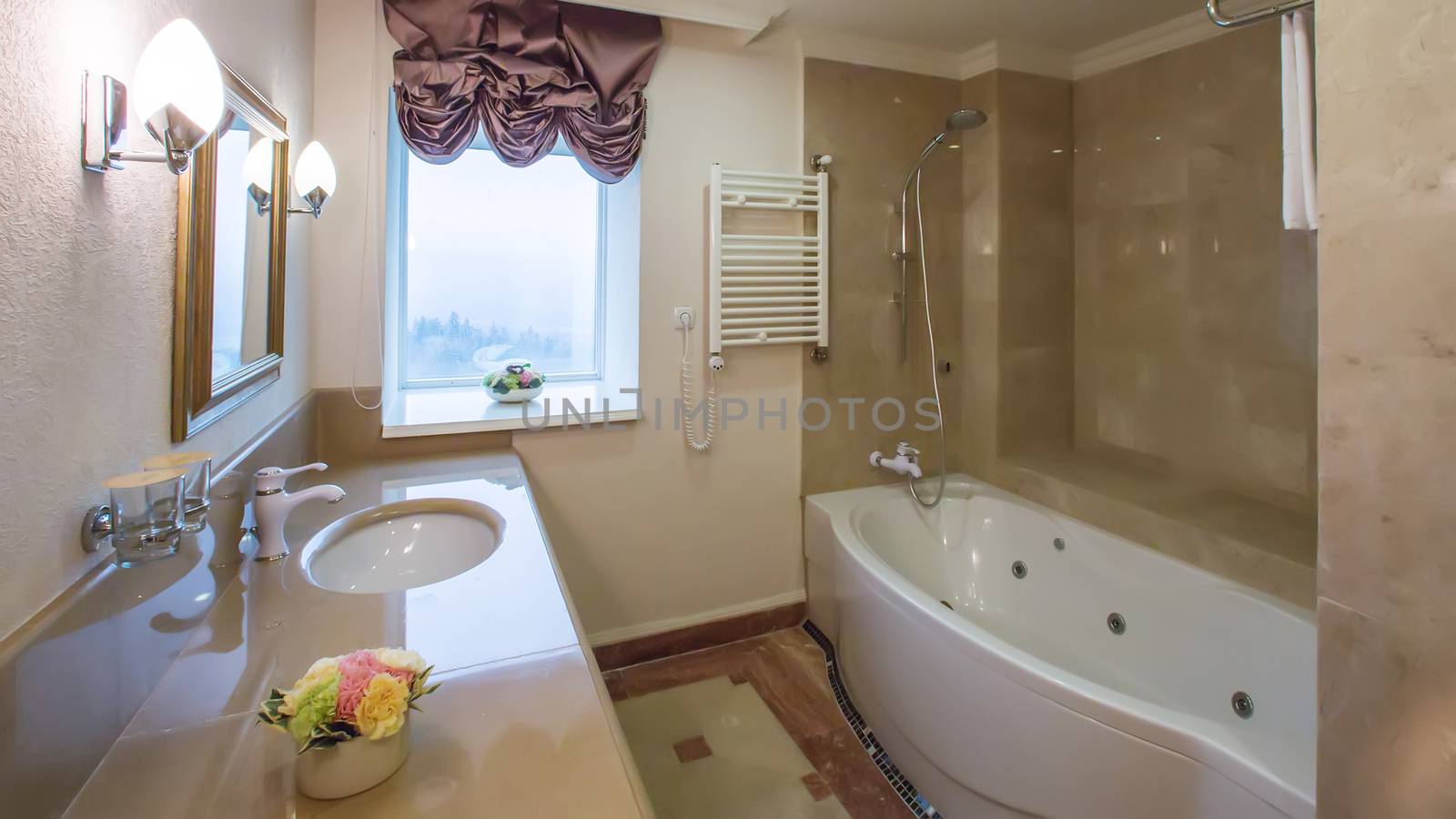luxury bathroom interior complete with granite and beautiful tiled floors and walls.