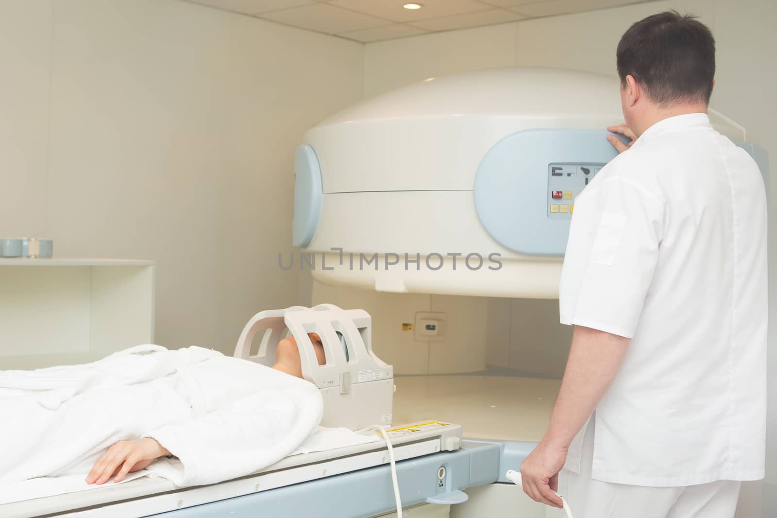 doctor examining woman at Magnetic resonance imaging