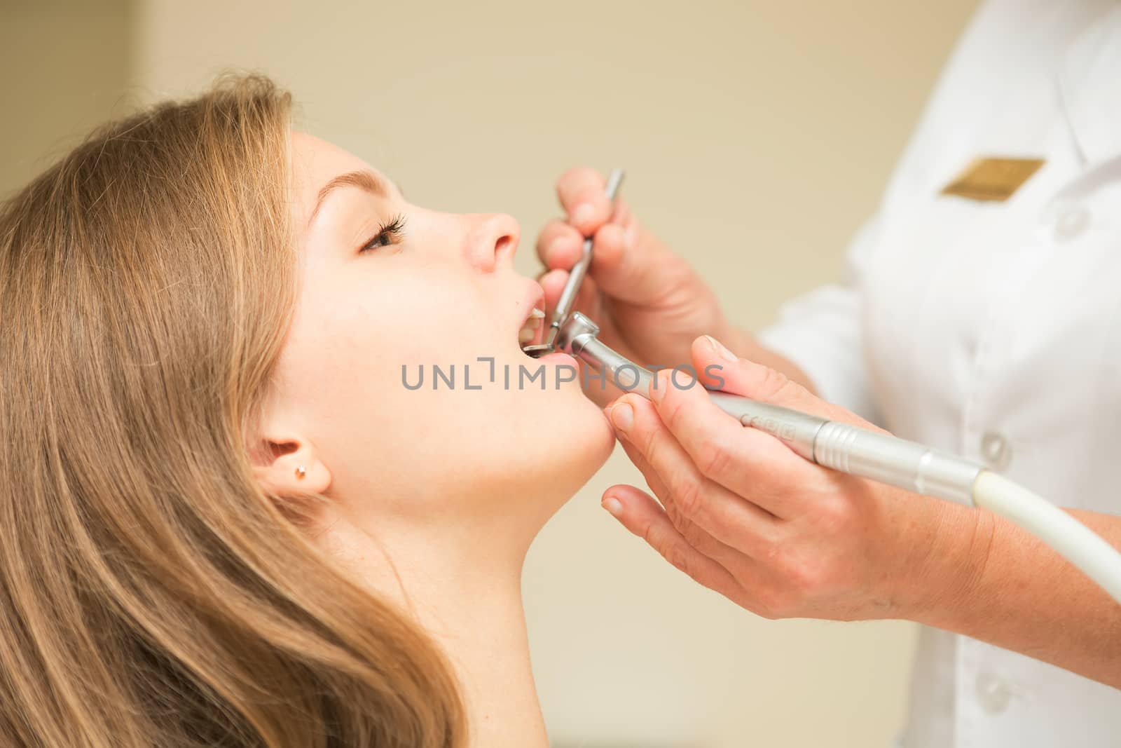 Dentist curing a female patient. Dentist Background