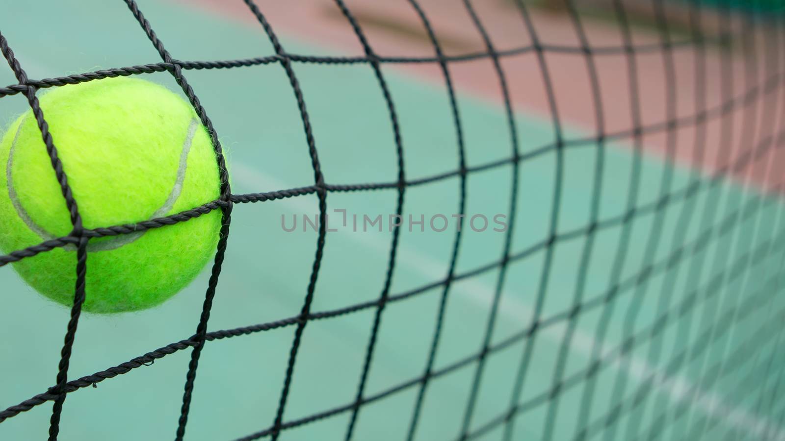 Tennis ball in net by sarymsakov