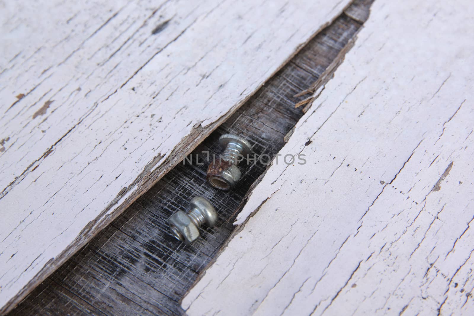 closeup on a pile of screws on old wood