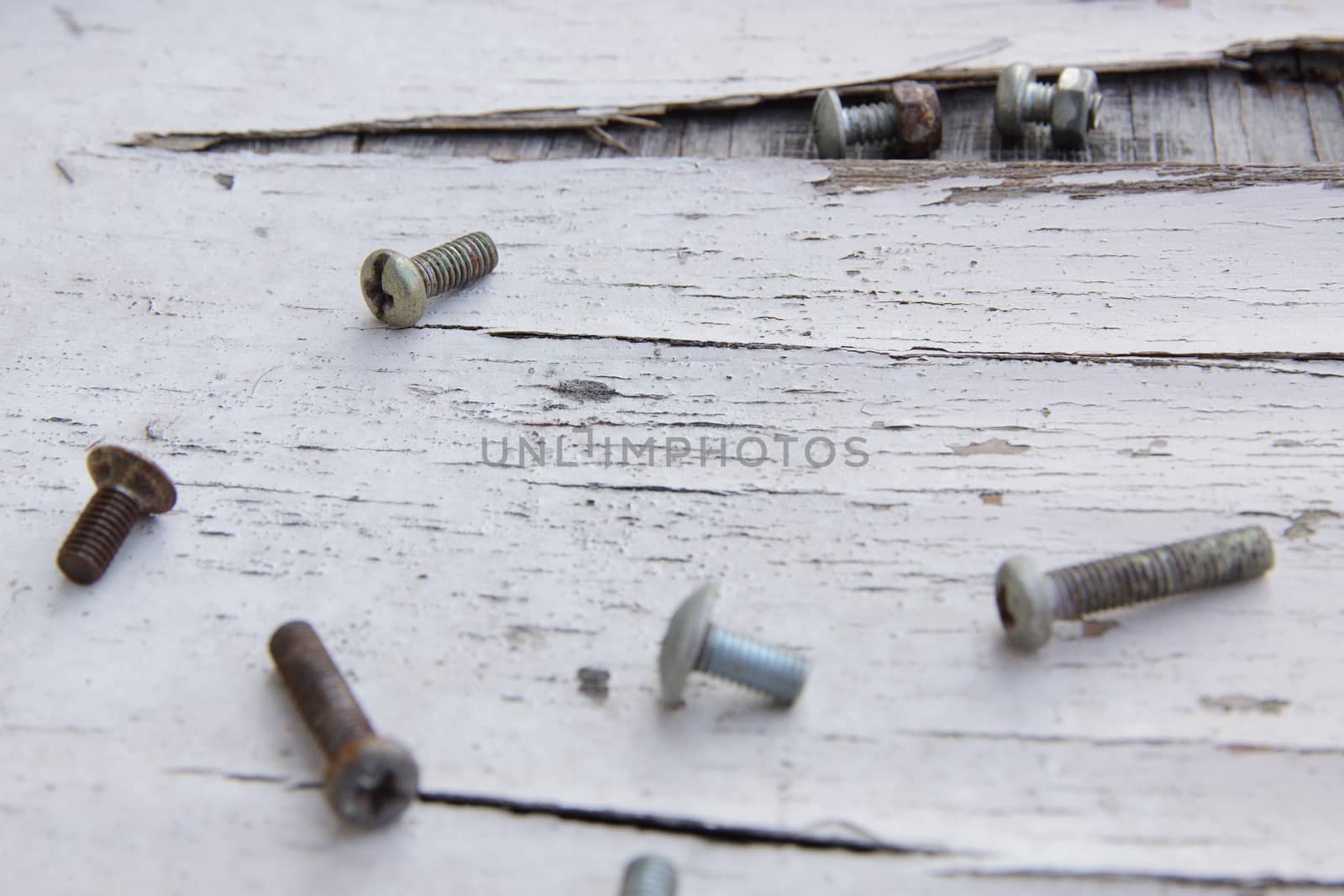 closeup on a pile of screws on old wood