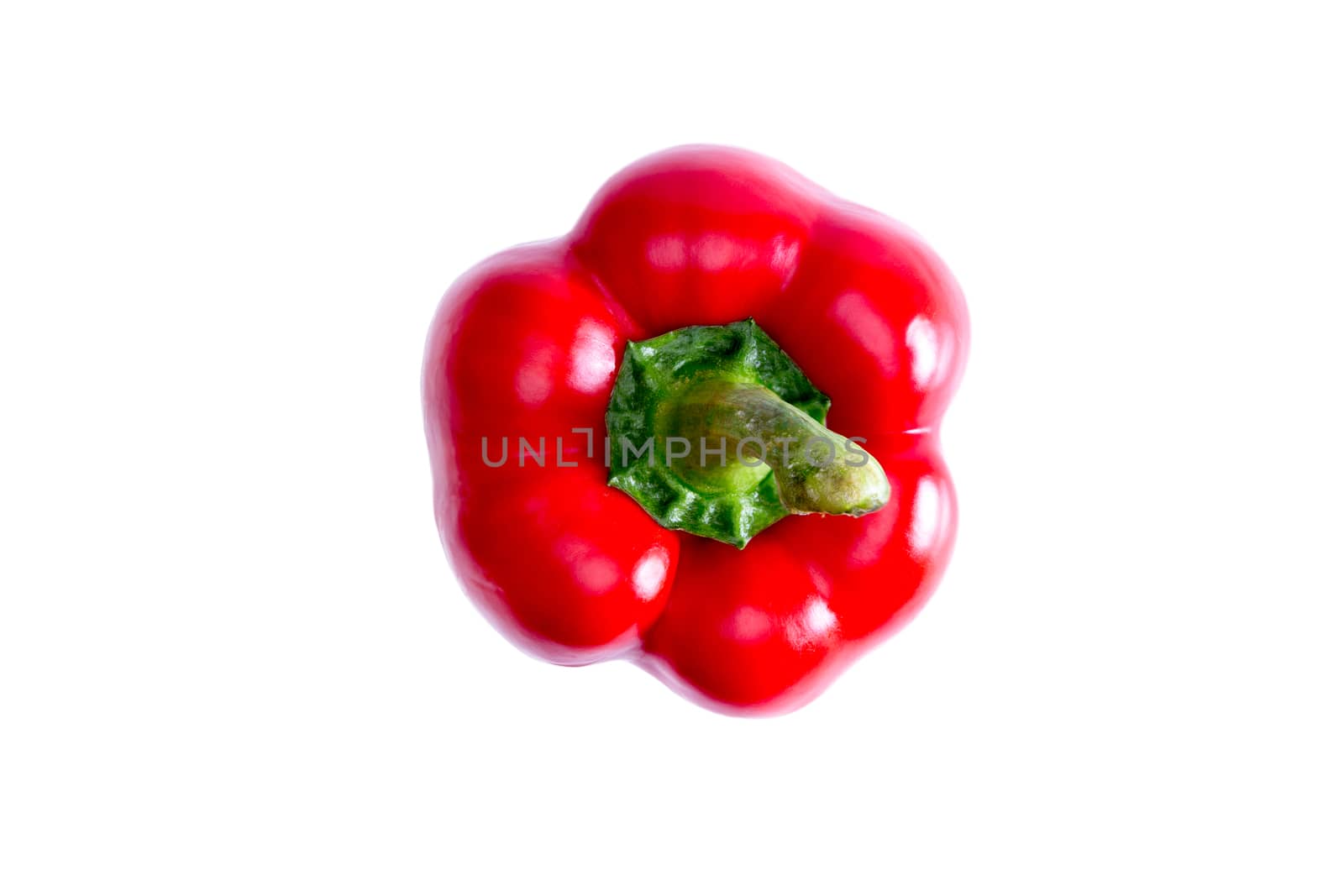 Fresh succulent red bell pepper with its green stalk, a rich source of vitamin c, the antioxidant lycopene, and active against cardiovascular disease, viewed from above on white with copyspace