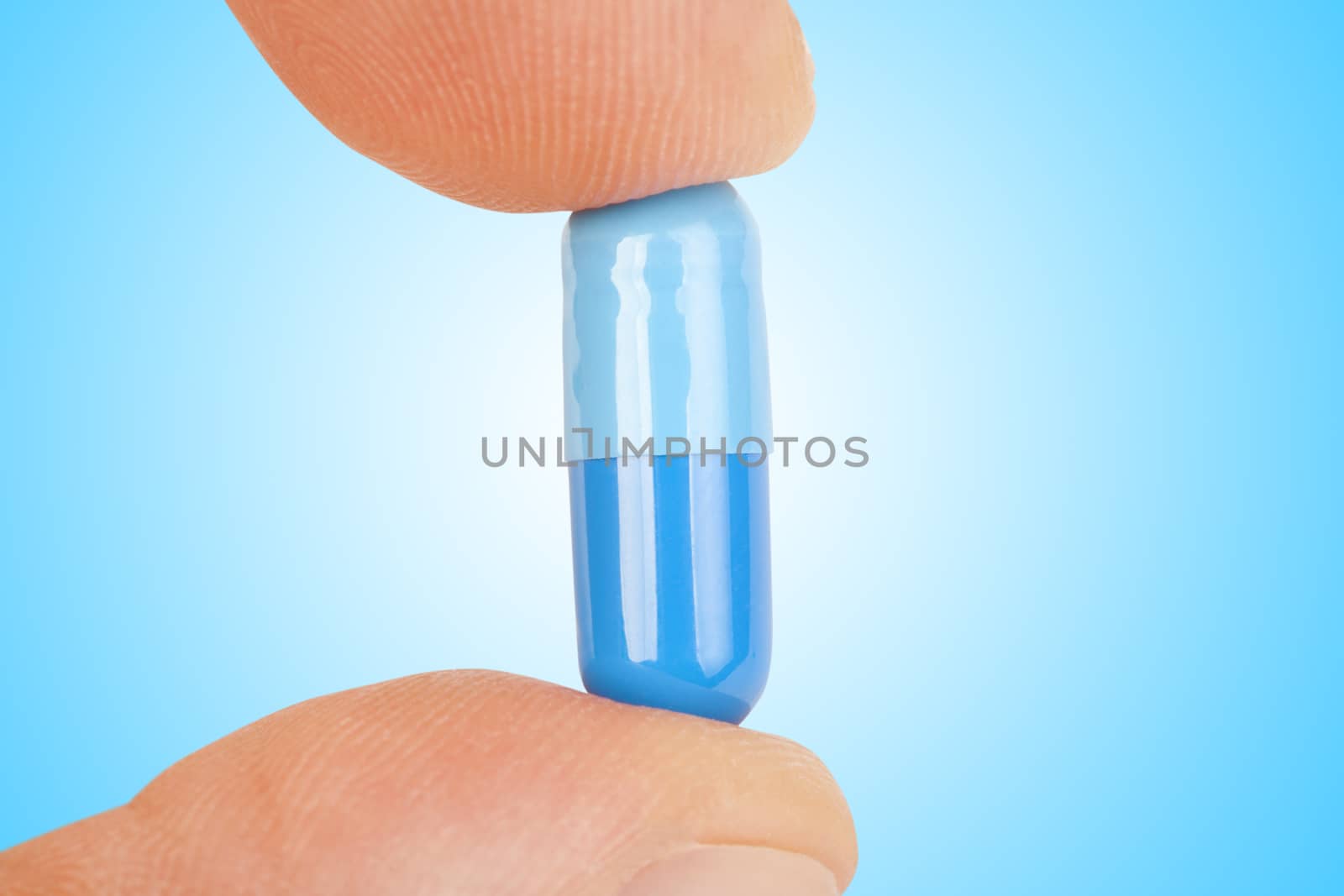 Capsule pills in fingers by alexkalina