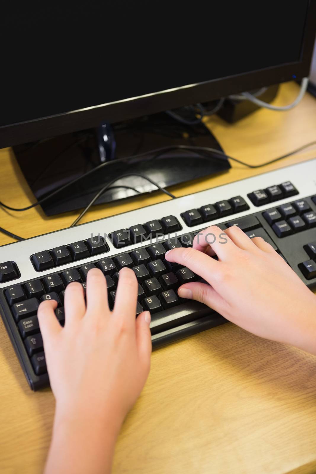 Student working on computer in classroom at the university