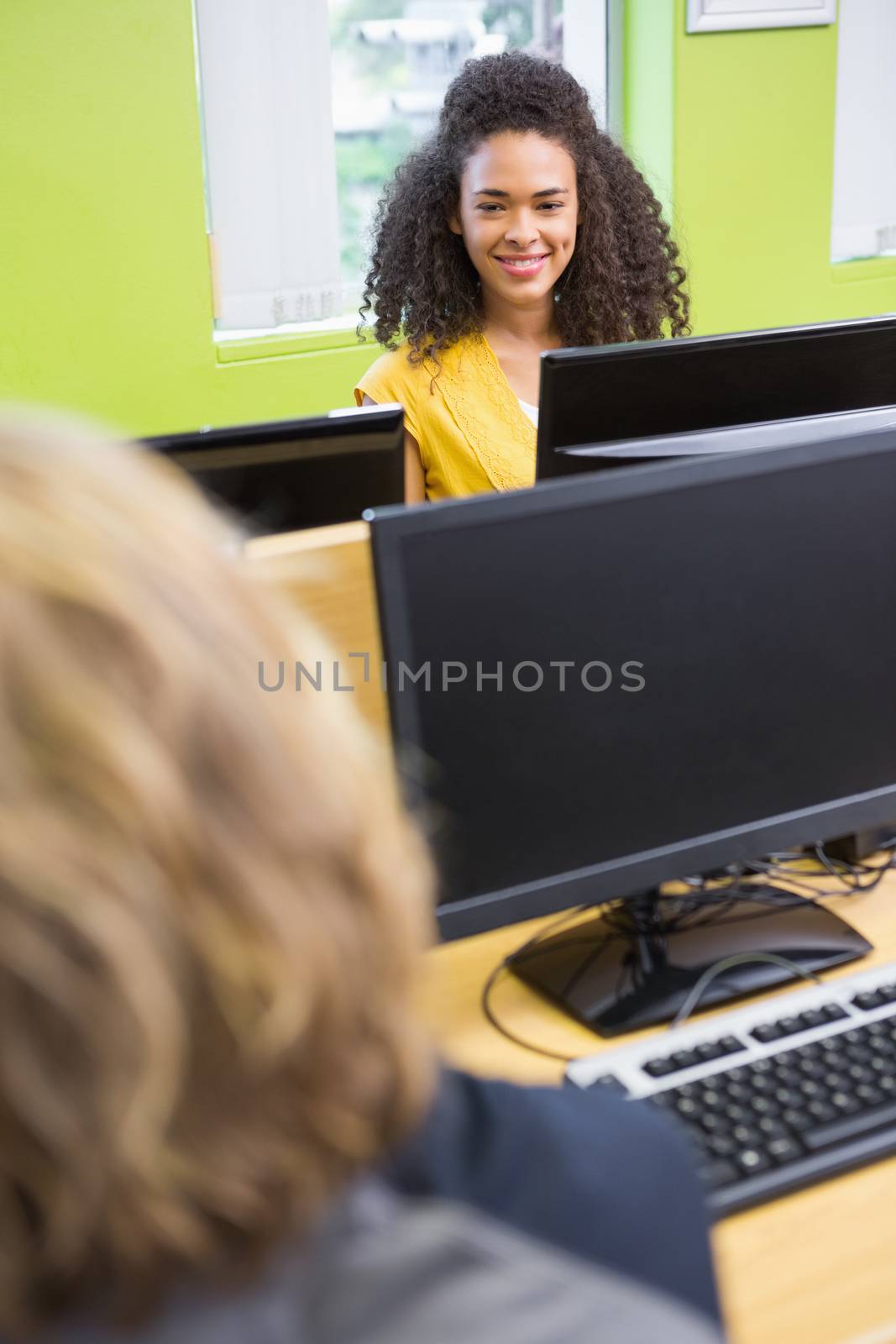 Student working on computer in classroom by Wavebreakmedia