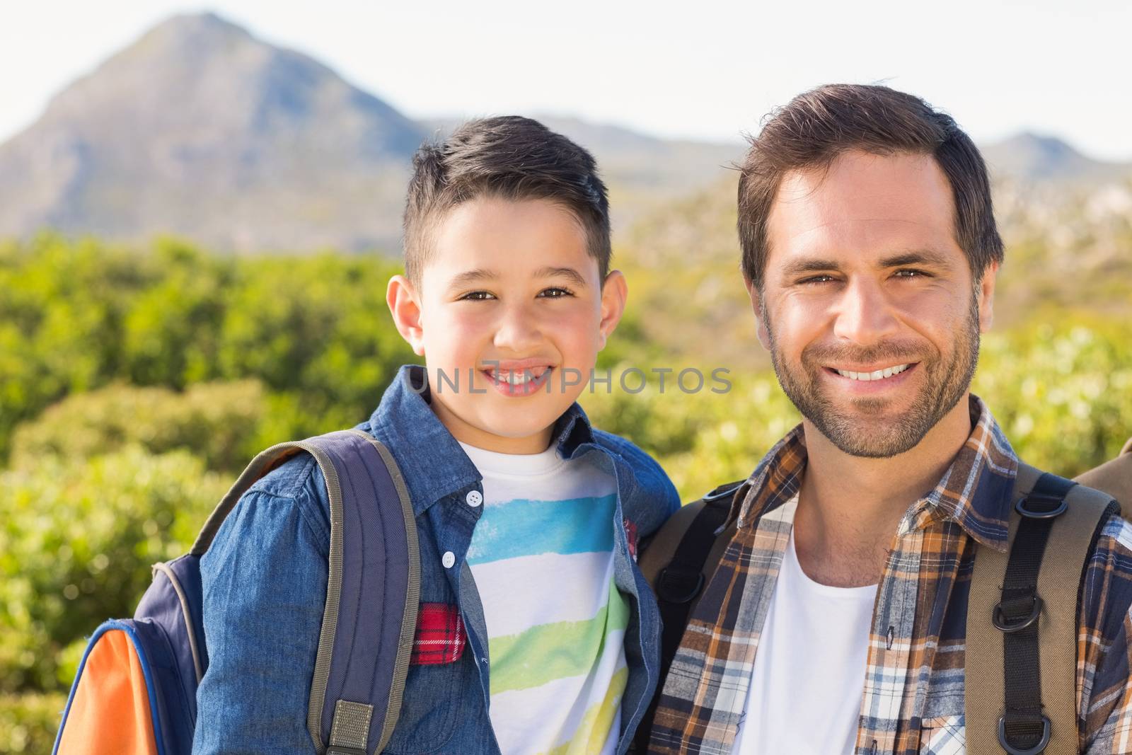 Father and son on a hike together on a sunny day