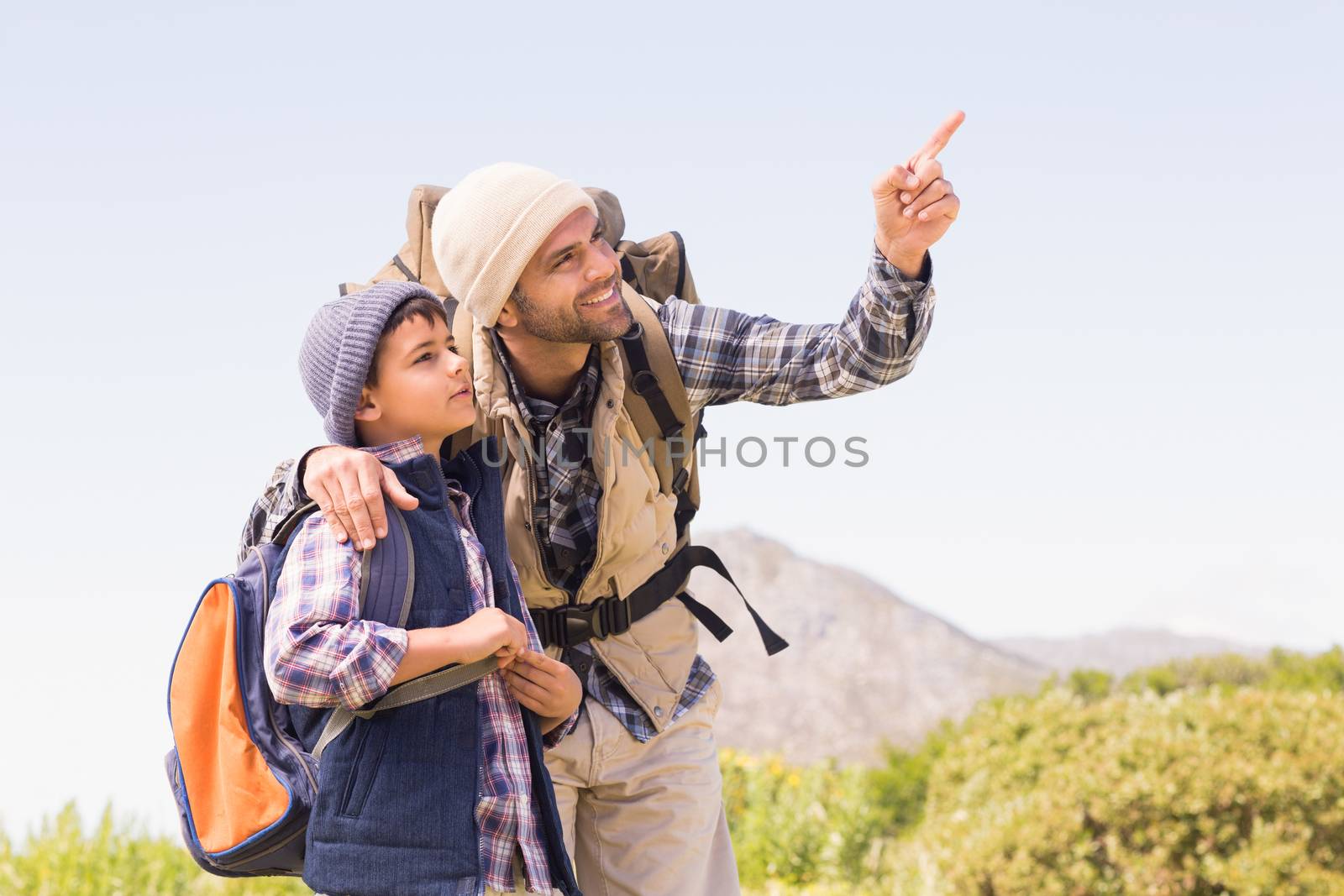 Father and son hiking in the mountains on a sunny day