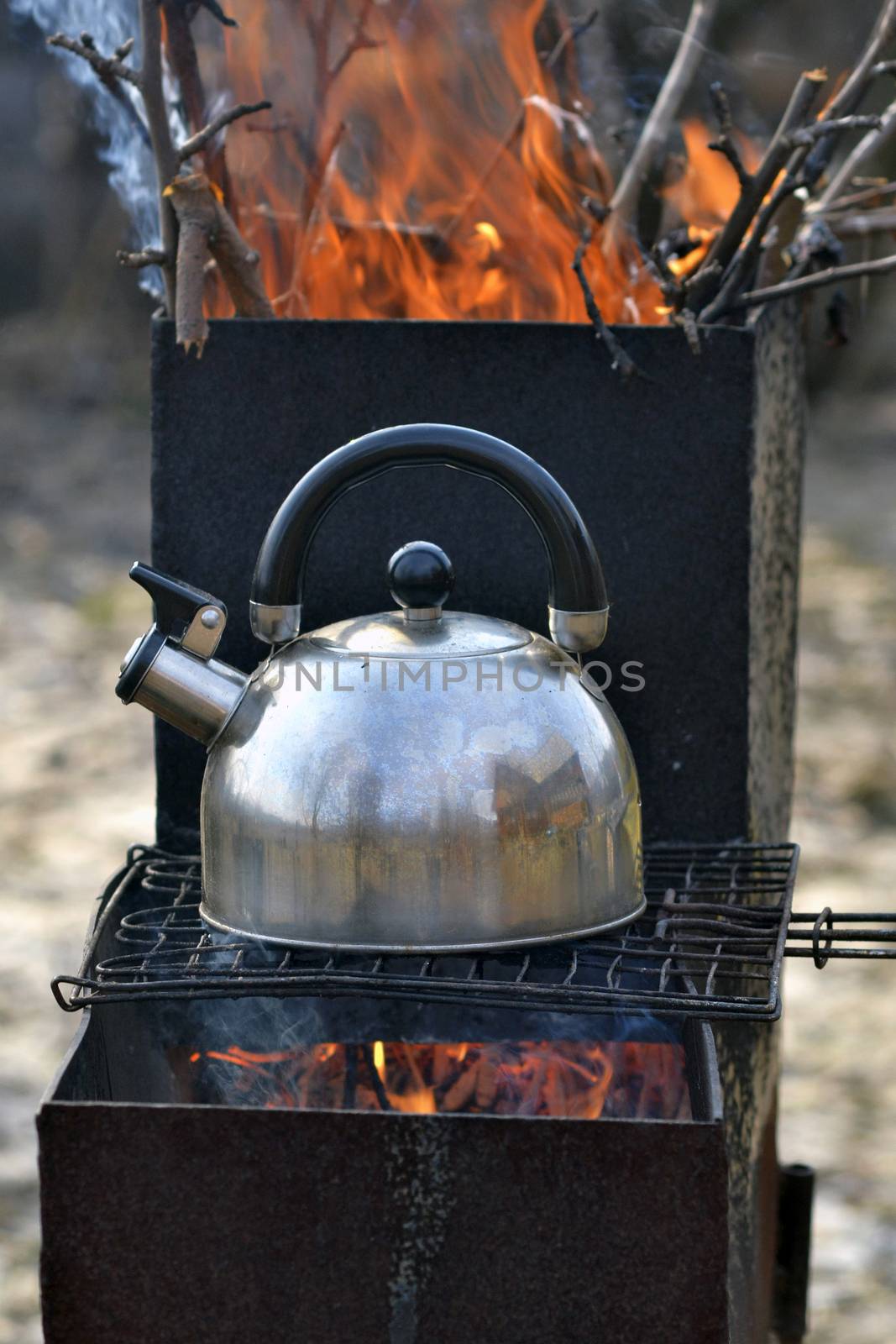the whistling kettle begins to boil on a brazier by veronka72