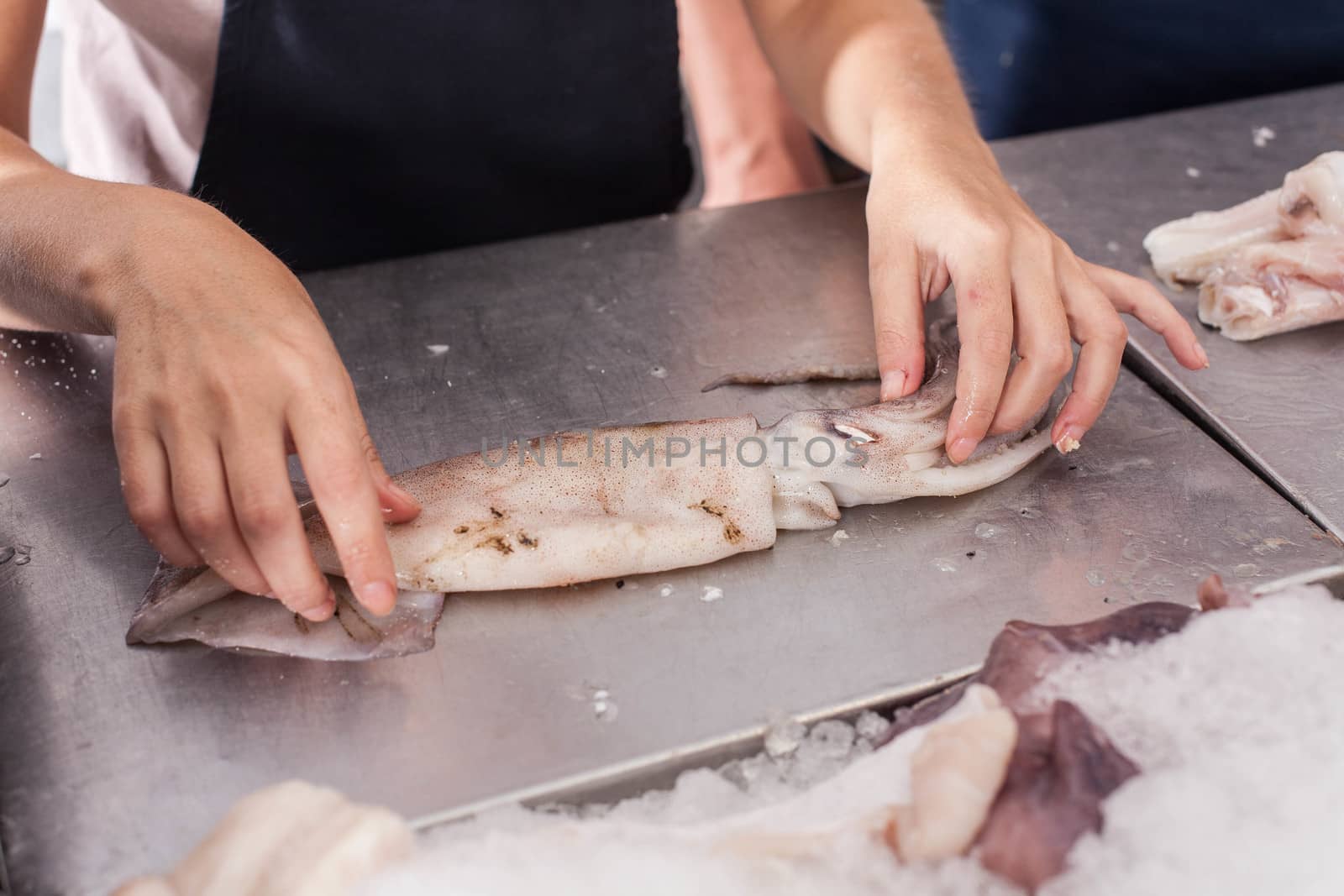 Woman cutting a squid