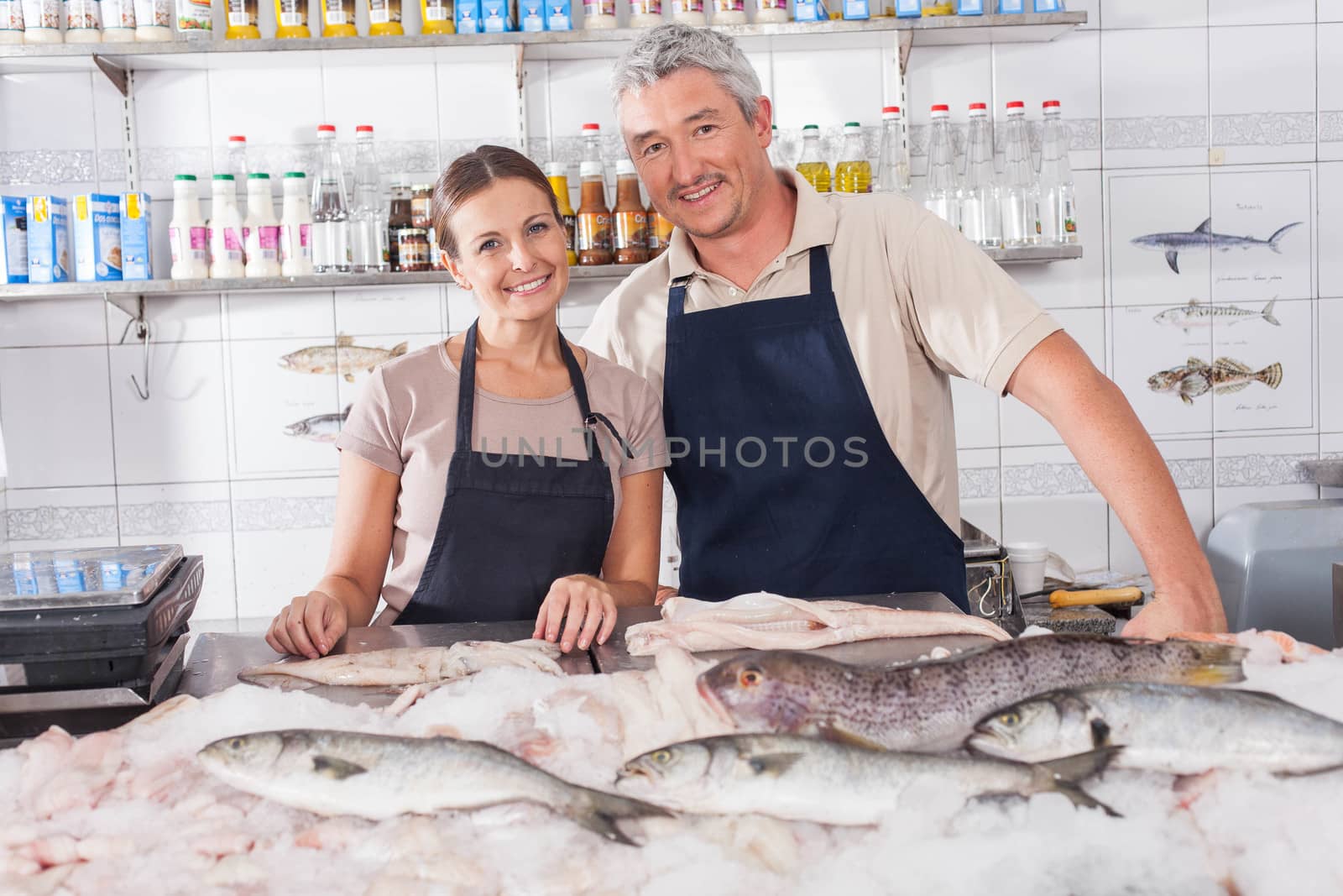 Couple selling in a fish shop