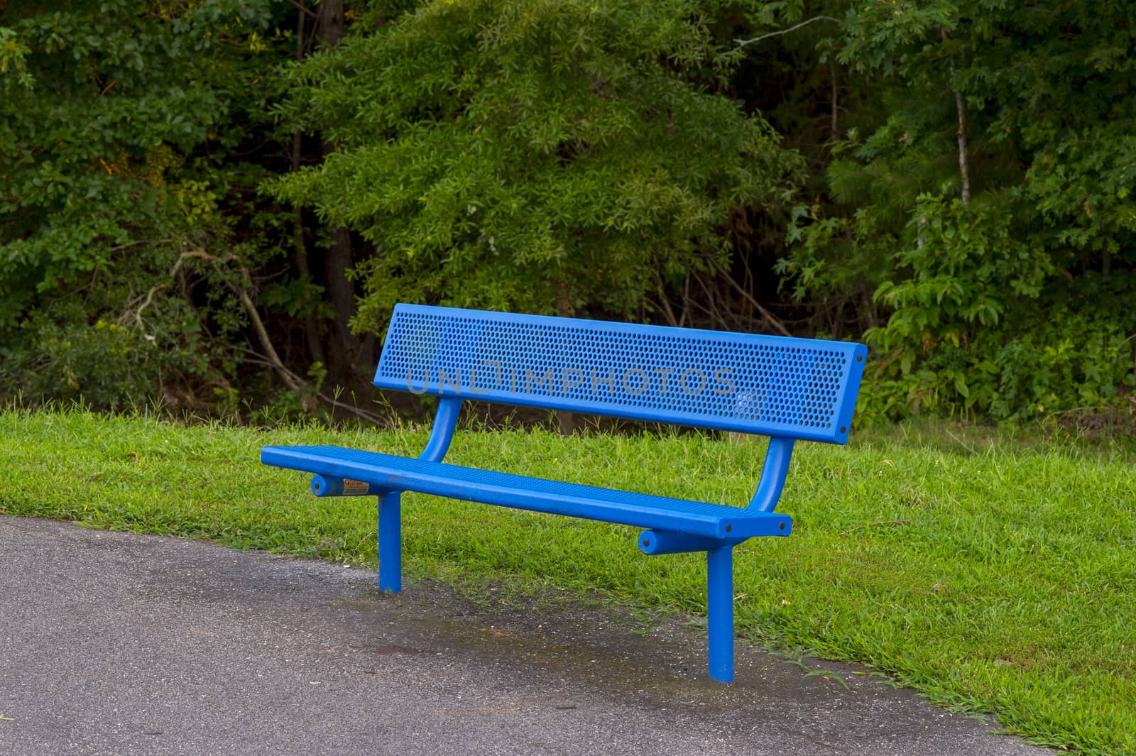 a metallic park bench on an overcast day