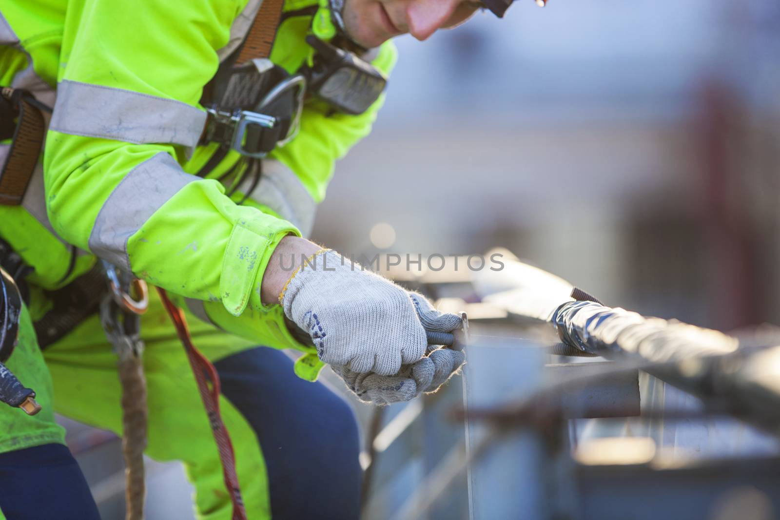 Closeup of industrial climber working on roof of building