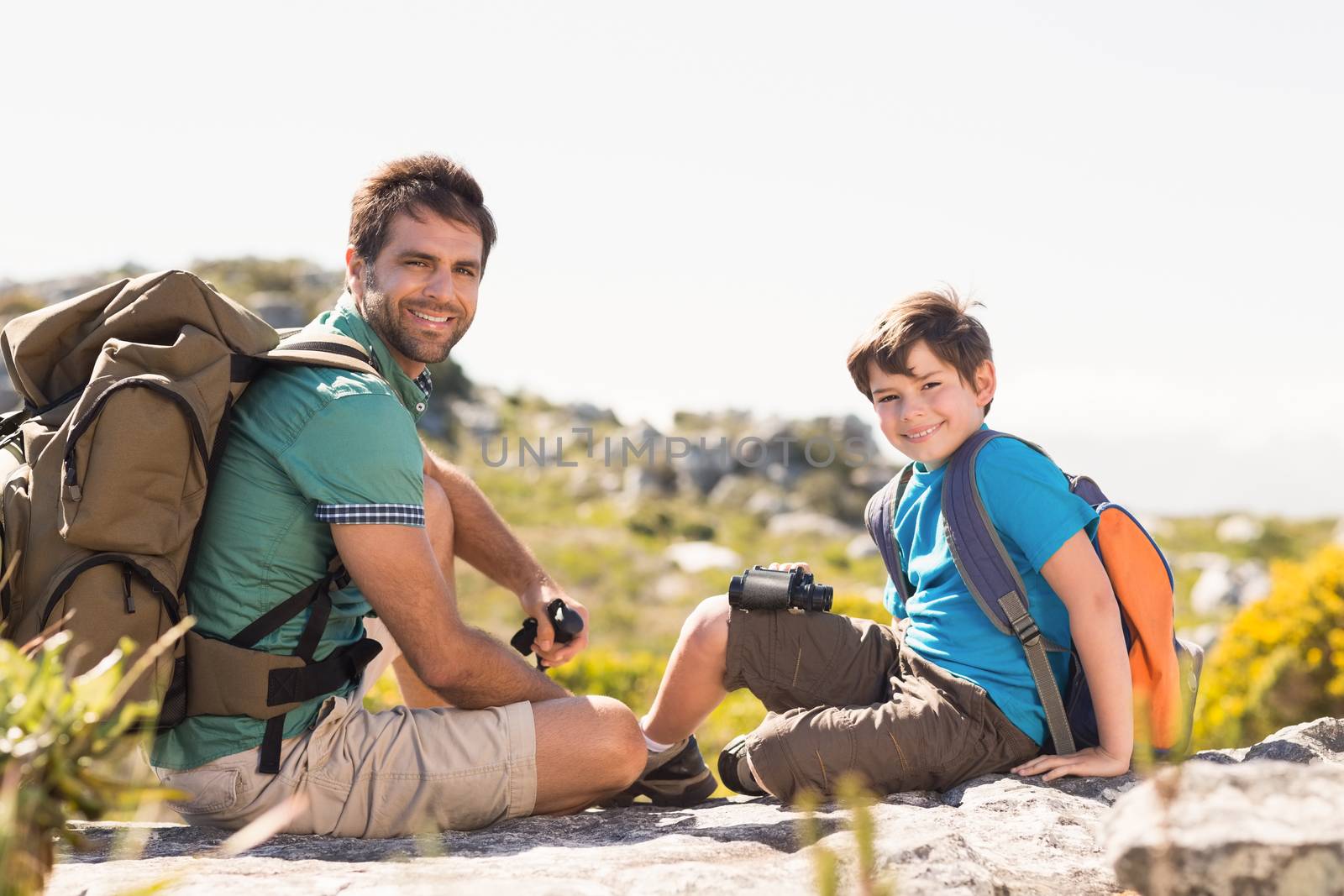 Father and son hiking through mountains by Wavebreakmedia