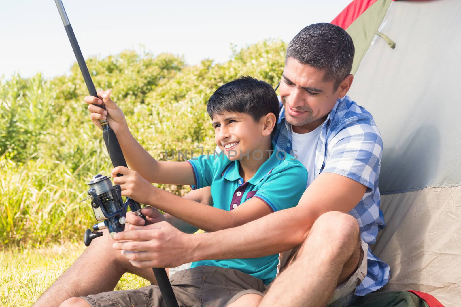 Father and son beside tent by Wavebreakmedia