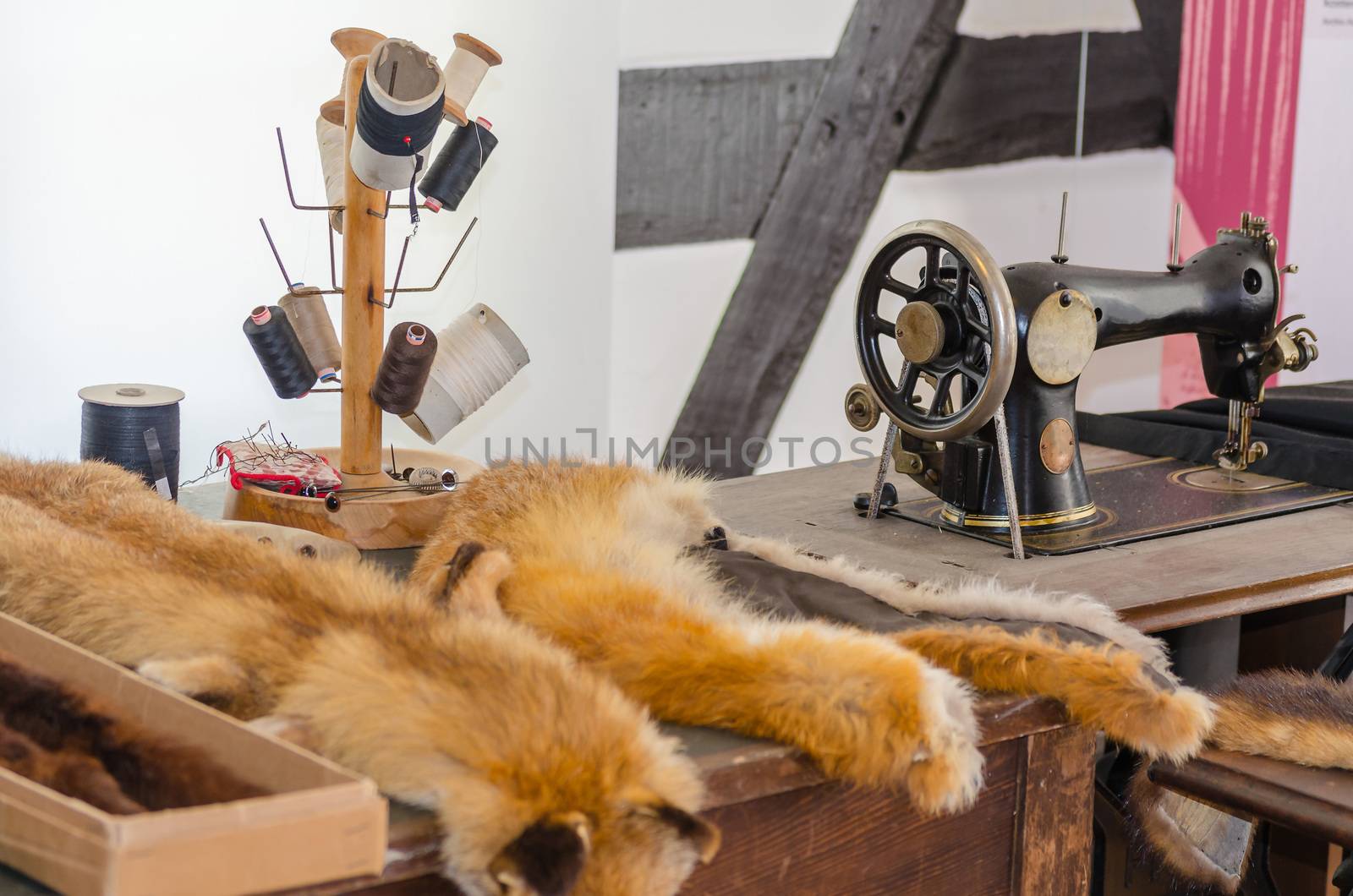 View of an old sewing in a sewing factory. With an antique sewing machine and accessories.