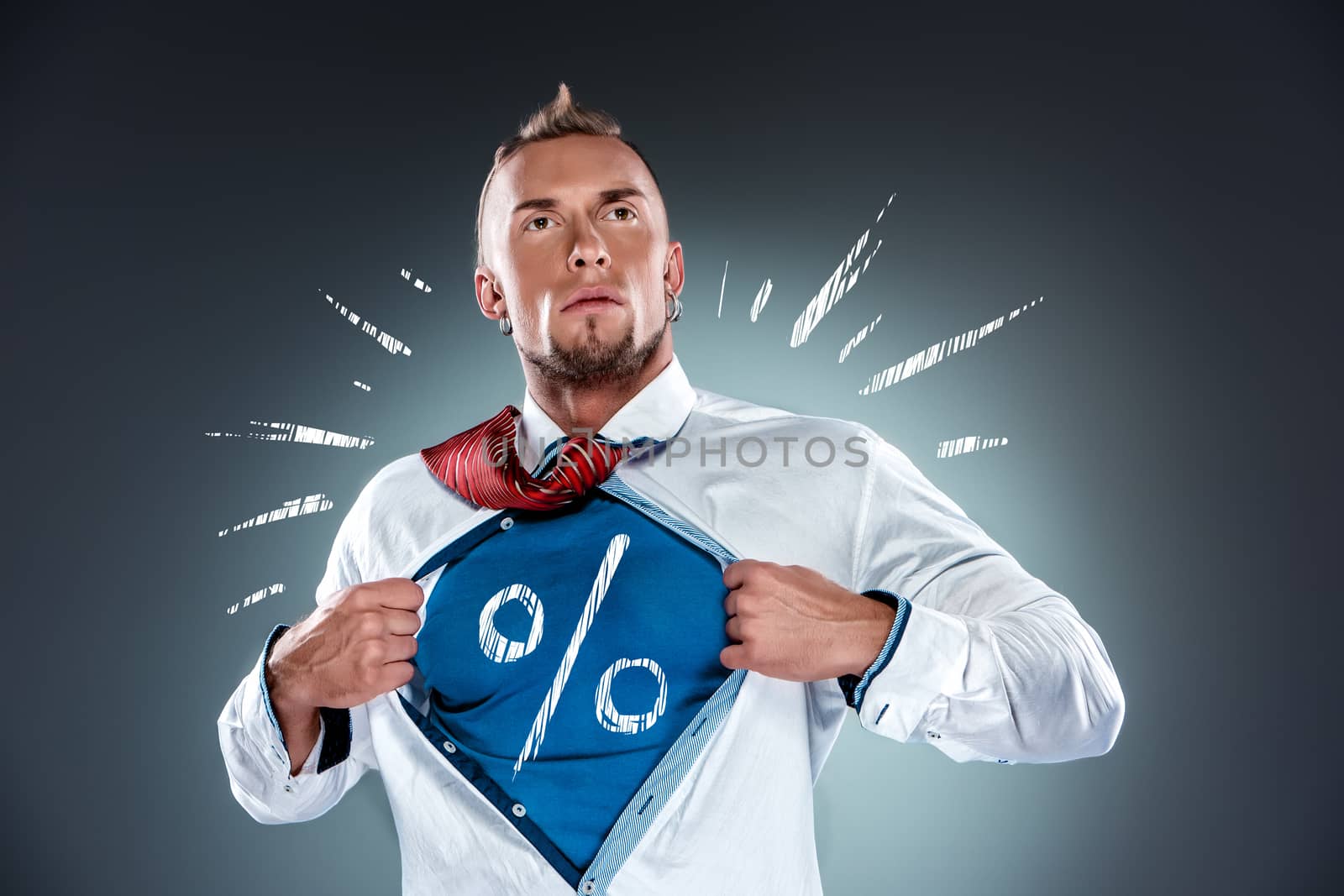 businessman acting like a super hero and tearing his shirt off on a gray background