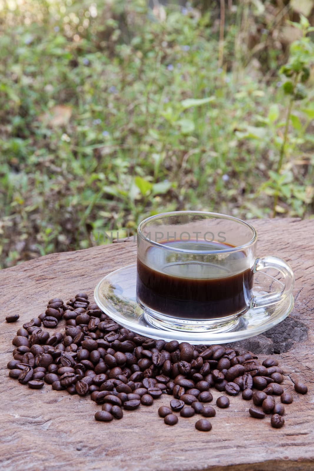 hot coffee with coffee beans on old wood