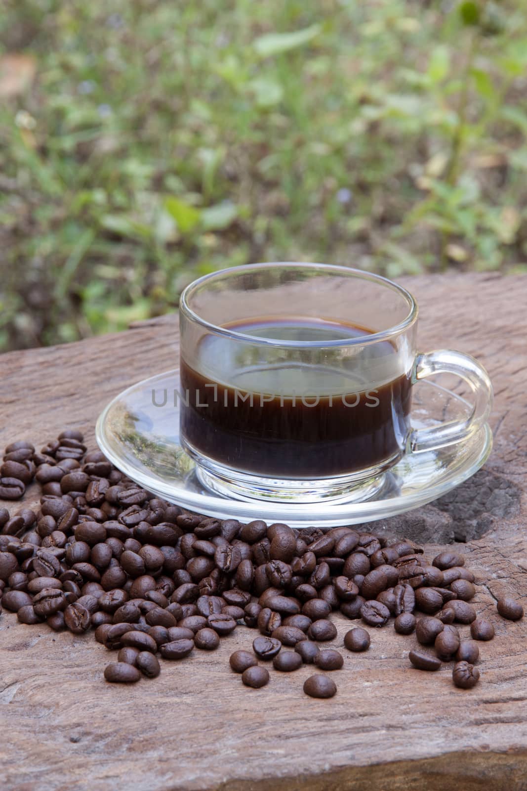 hot coffee with coffee beans on old wood